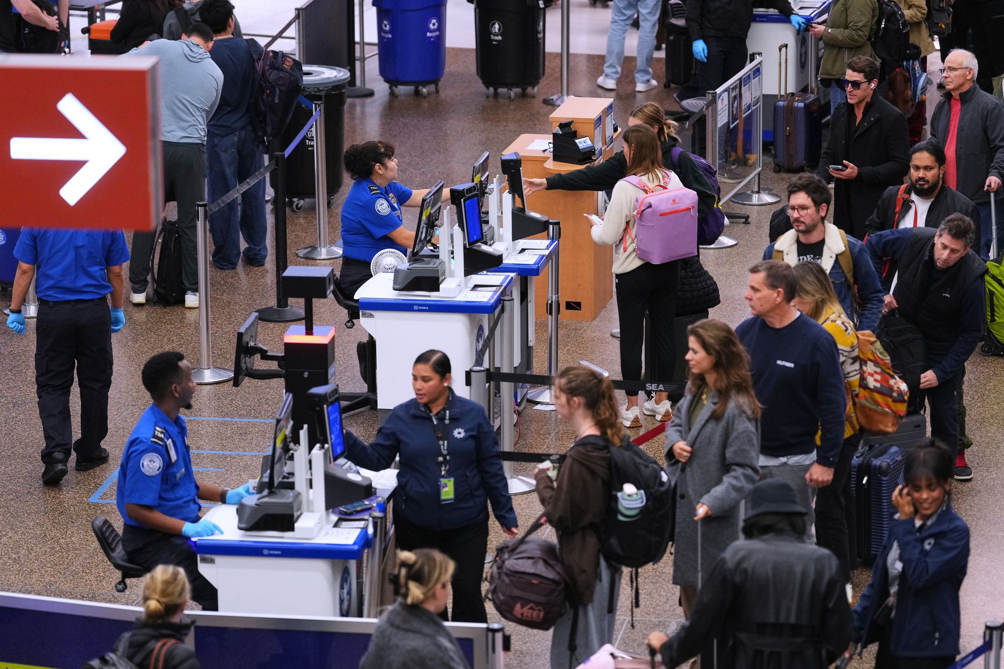 Travelers wait at a security checkpoint at Seattle-Tacoma International Airport on Thursday November 6 2025
