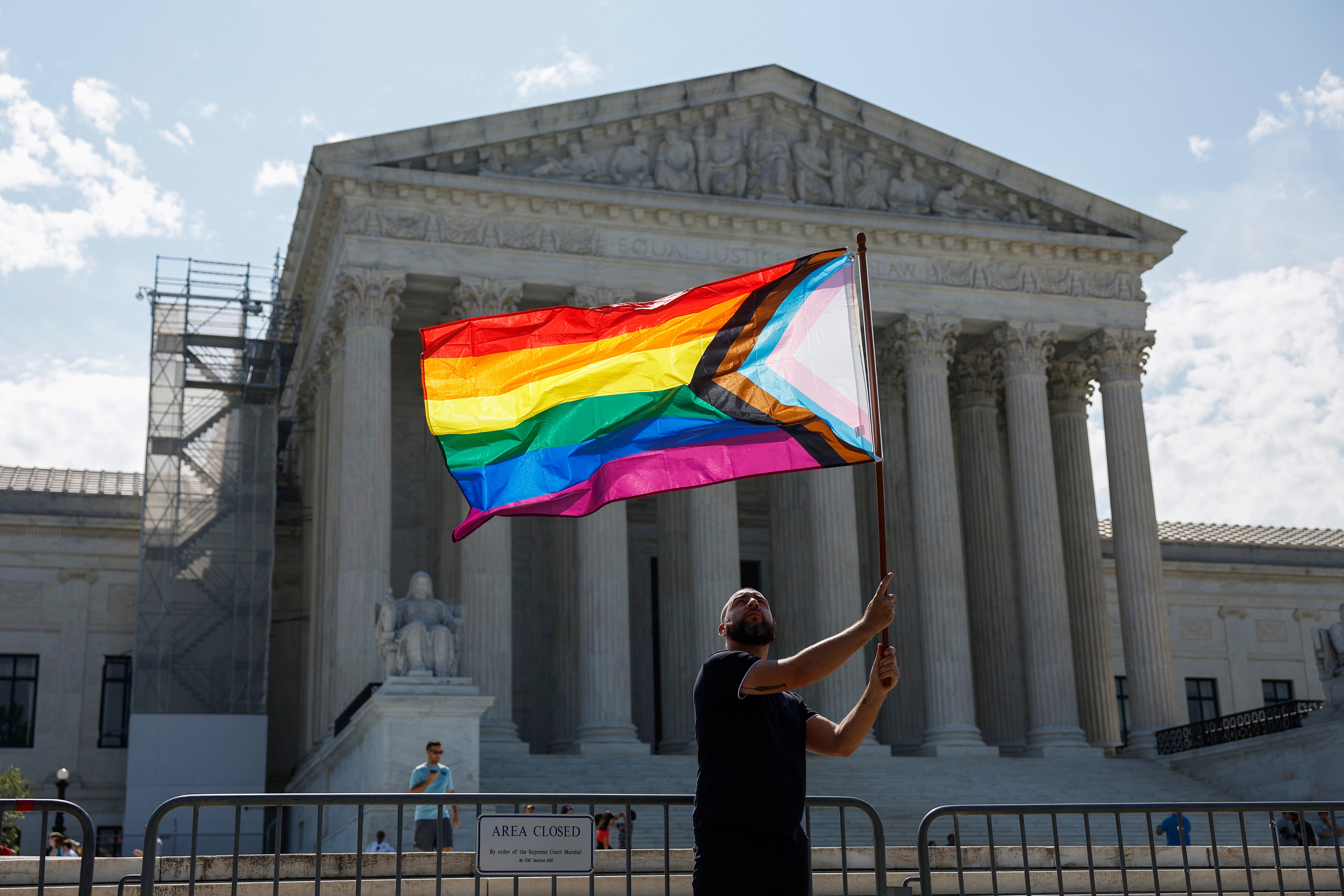 Same-sex marriage supporter Vin Testa, of Washington, DC, waves a LGBTQIA pride flag in front of the U.S. Supreme Court Building