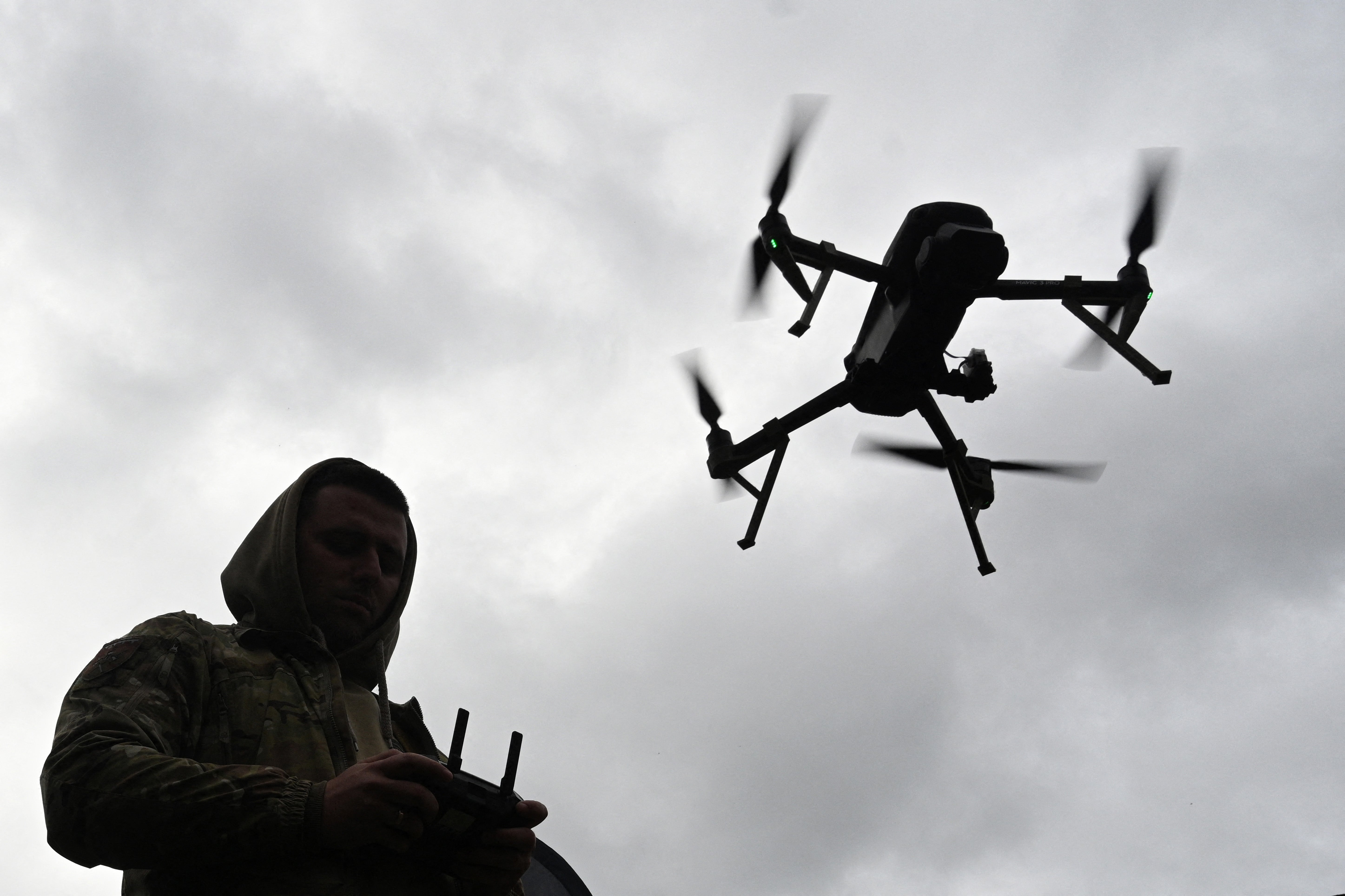 A Ukrainian serviceman operates a drone during the 'Wild Drones' drone racing competition, which simulates combat conditions, in Kamianets-Podilskyi, Khmelnytsky region on October 5, 2025, amid the Russian invasion of Ukraine