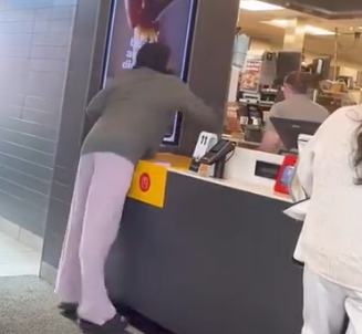 In a shocking turn of events, the customer then launches a cup of hot coffee over the employee