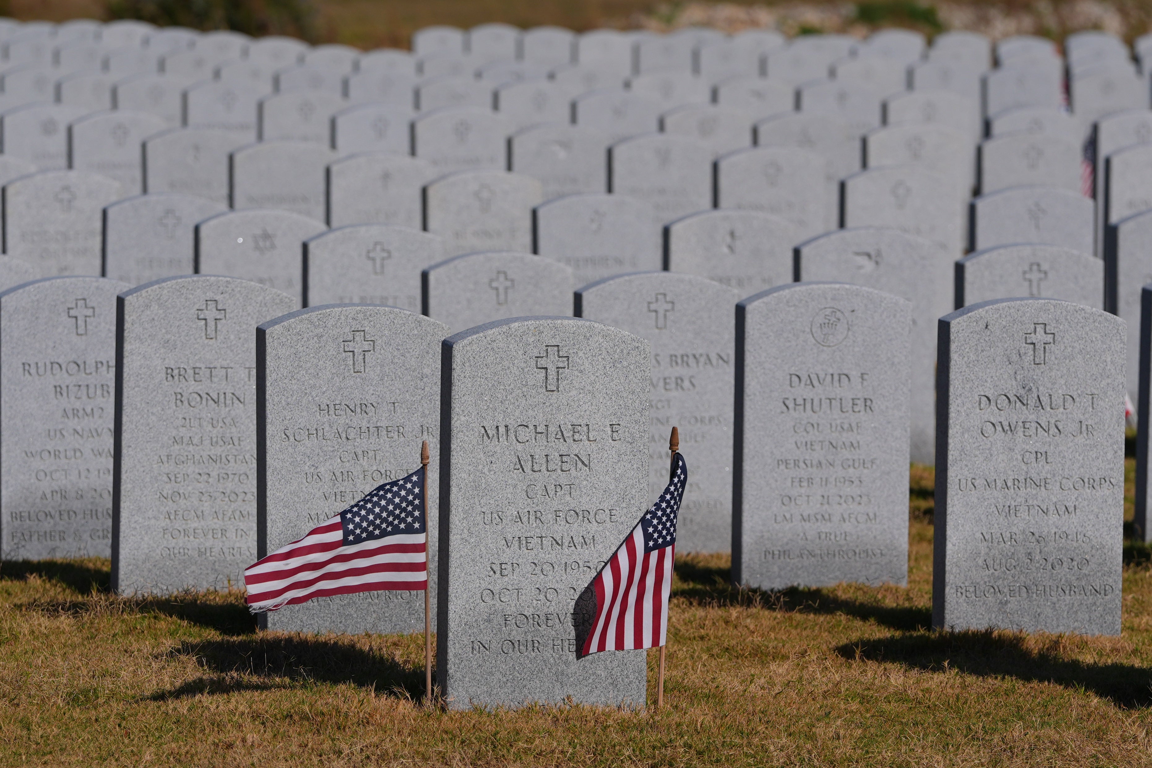 Grave markers of U.S. veterans are shown at the Dallas-Fort Worth National Cemetery where the upcoming annual Veterans Day program has been canceled due to the federal government shutdown in Dallas, Tuesday, Nov. 4, 2025
