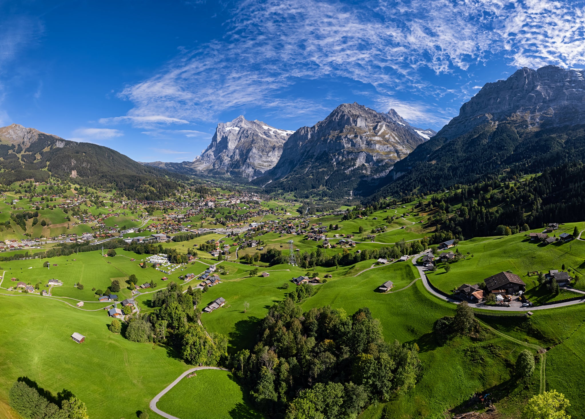 Titanic peaks tower over Grindelwald , including the Eiger (right), Mettenberg (middle), and the Wetterhorn (far left)