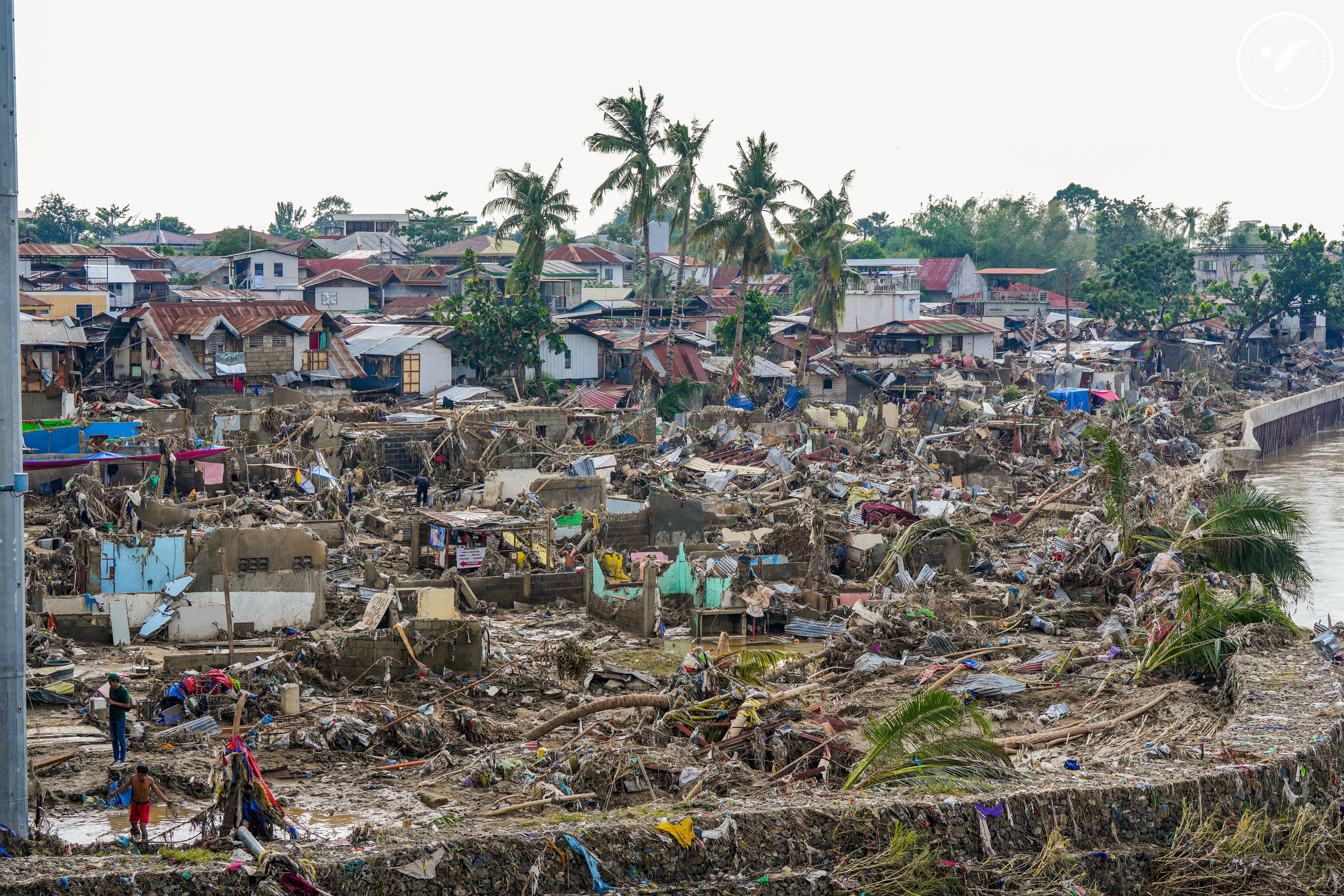 In this photo provided by the Malacanang Presidential Communications Office, damaged homes beside Mananga Bridge in Talisay, Cebu Province, central Philippines on Friday Nov. 7, 2025 after Typhoon Kalmaegi devastated the province and claimed lives. (Malacanang Presidential Communications Office via AP)