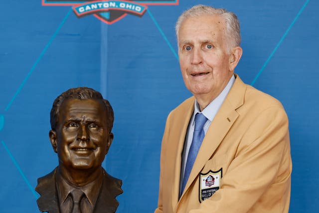 <p>Paul Tagliabue, posing with his bust at the Pro Football Hall of Fame in Canton, Ohio, in 2021. His family announced Sunday that he had died, aged 84</p>