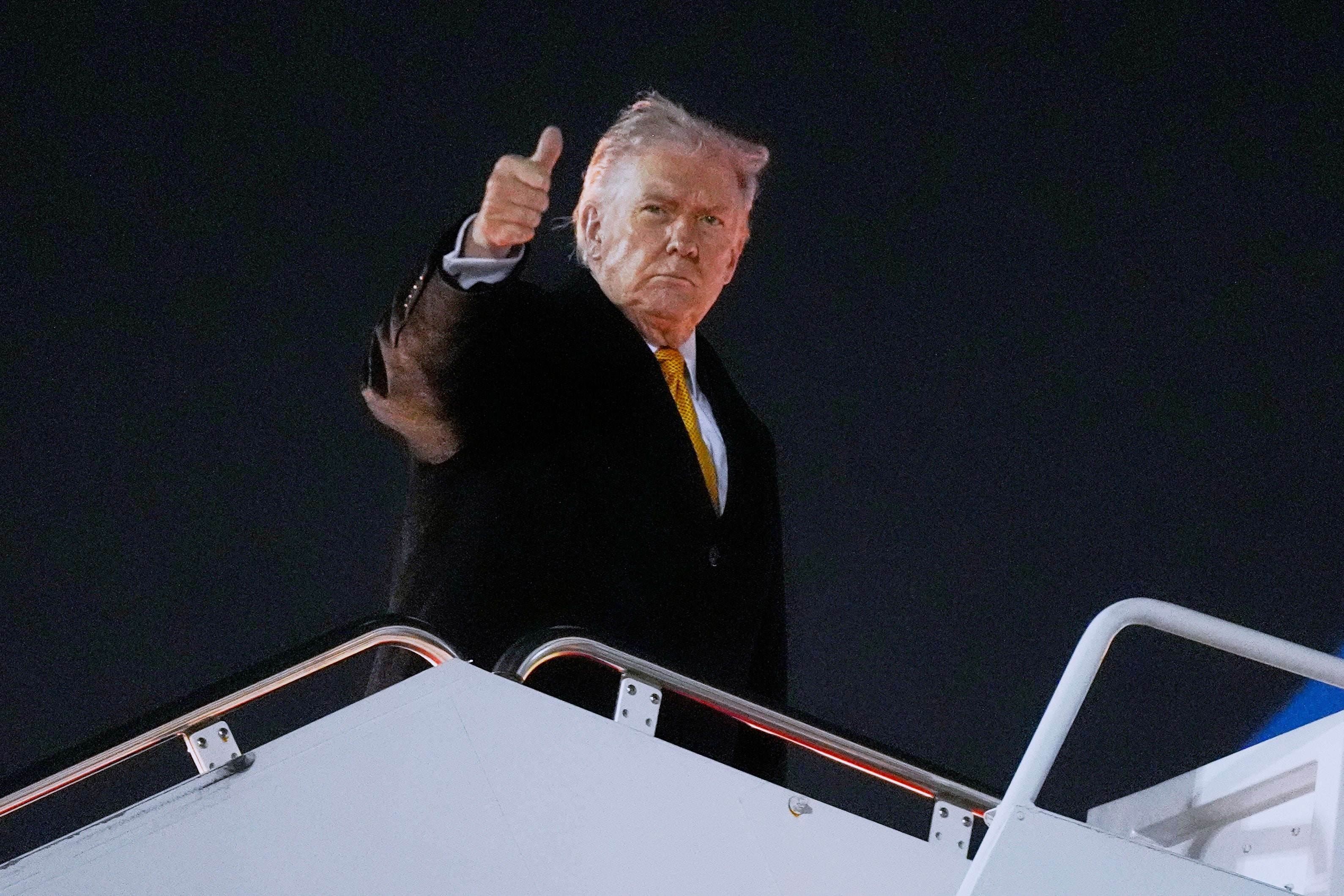 President Donald Trump boards Air Force One Friday on his way to his Mar-a-Lago estate in Palm Beach for a lavish party, amid the government shutdown