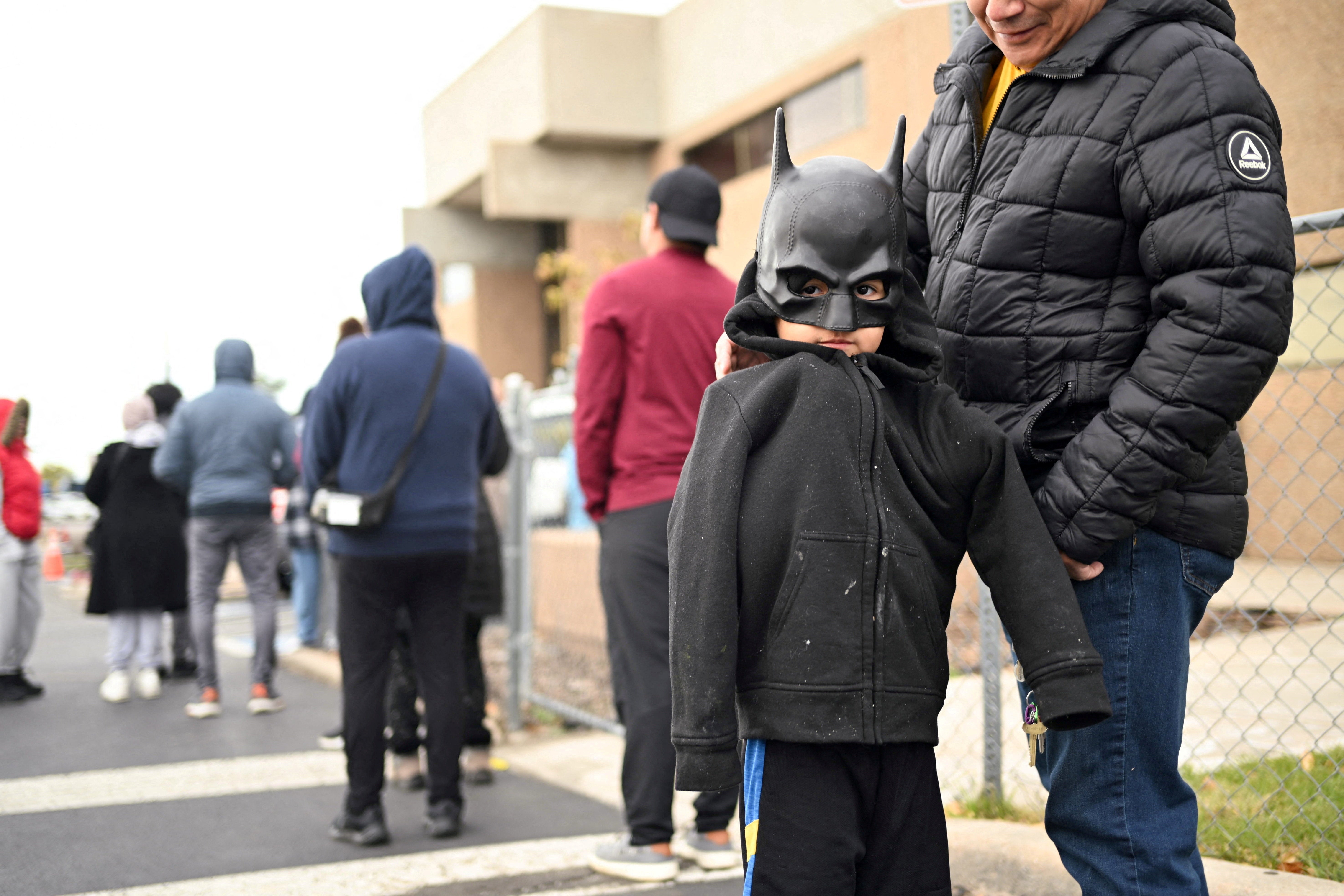 A boy dressed as Batman waits in line outside the Adams County Emergency Food Bank, weeks into the continuing government shutdown, in Commerce City, Colorado