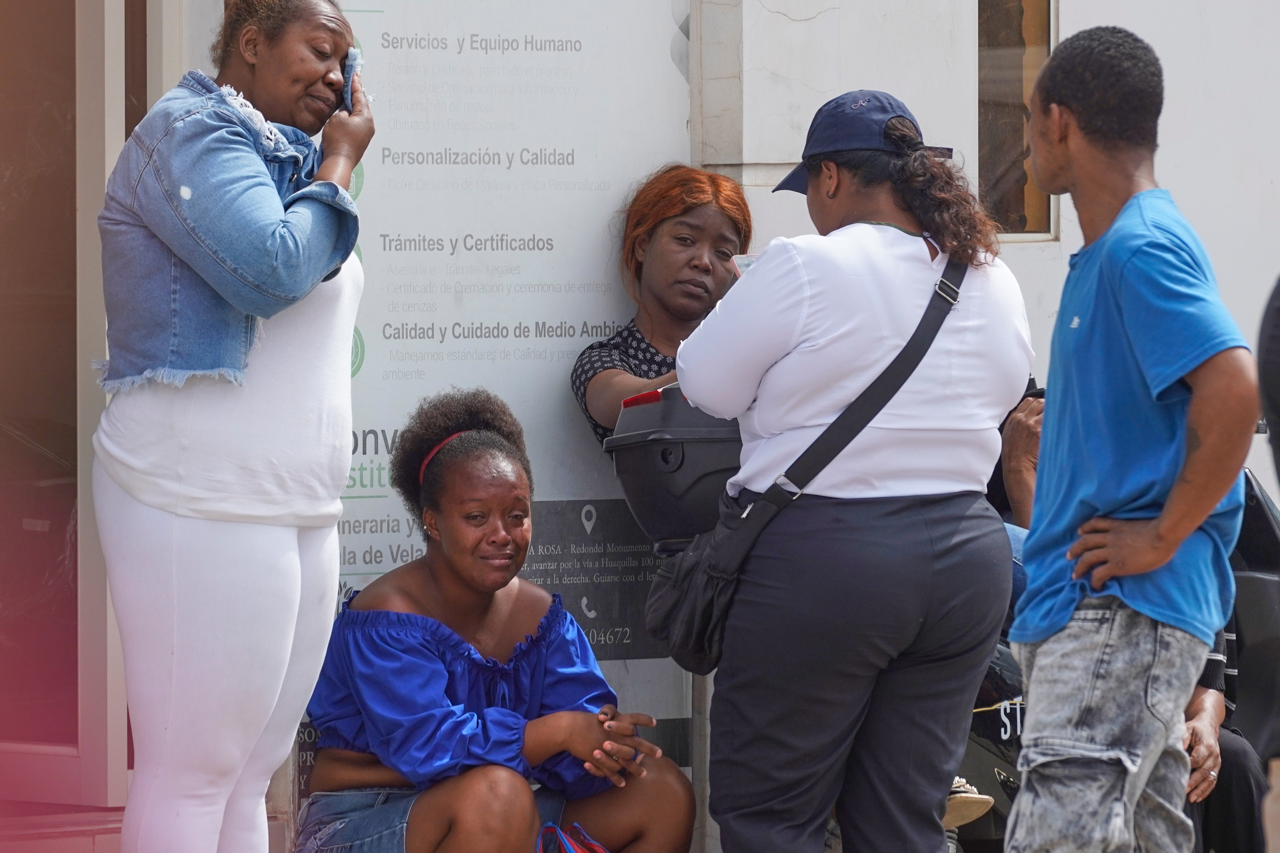 The relatives of prisoners who died during a clashes between inmates wait for the remains of their loved ones outside the morgue in Machala, Ecuador