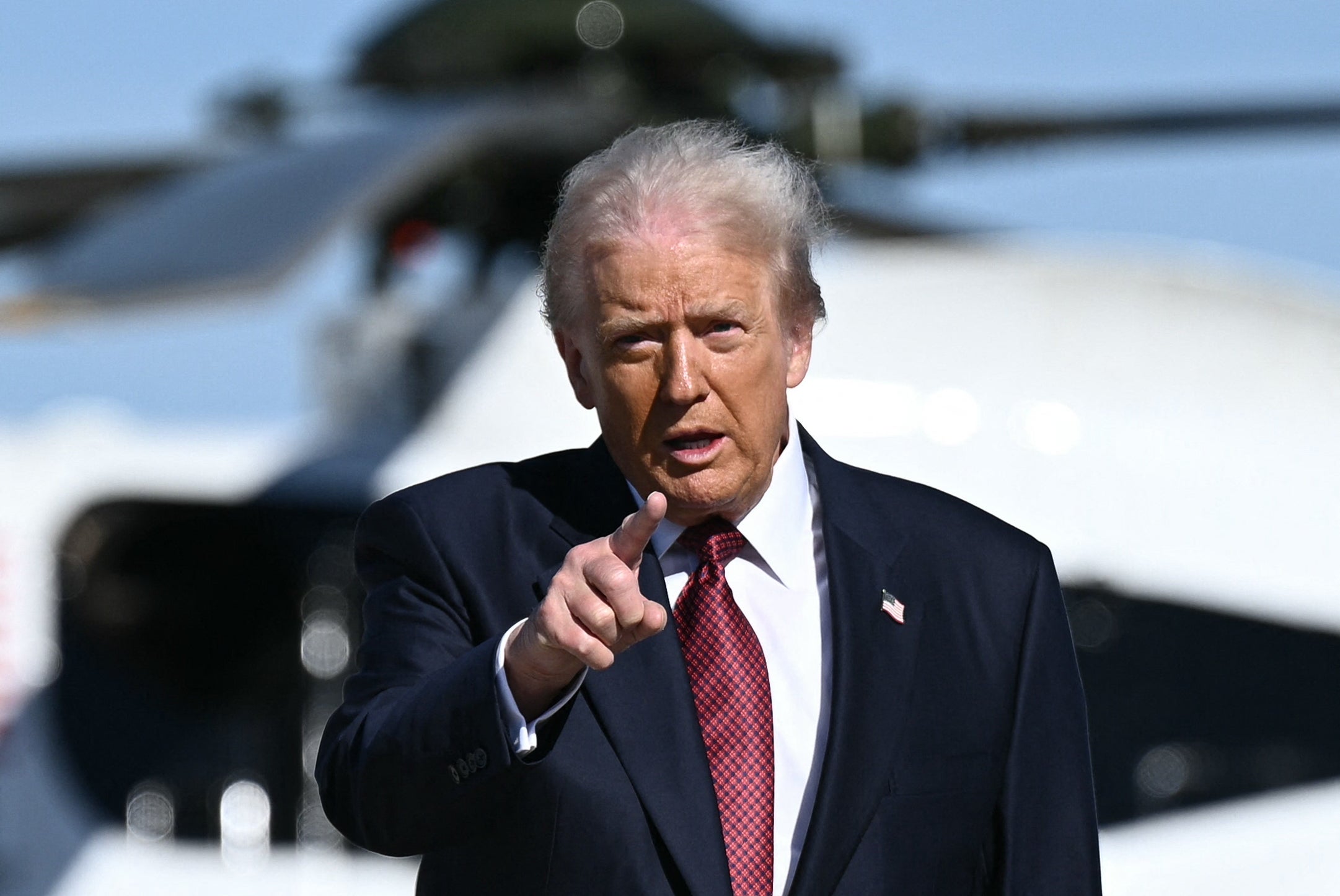 US President Donald Trump gestures as he walks to board Air Force One at Joint Base Andrews, Maryland on November 5, 2025. Trump is traveling to Miami to speak at the America Business Forum