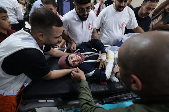 <p>Reuters journalist Raneen Sawafta is carried on a stretcher at the Rafidia Hospital in Nablus after being injured by Israeli settlers in occupied West Bank</p>