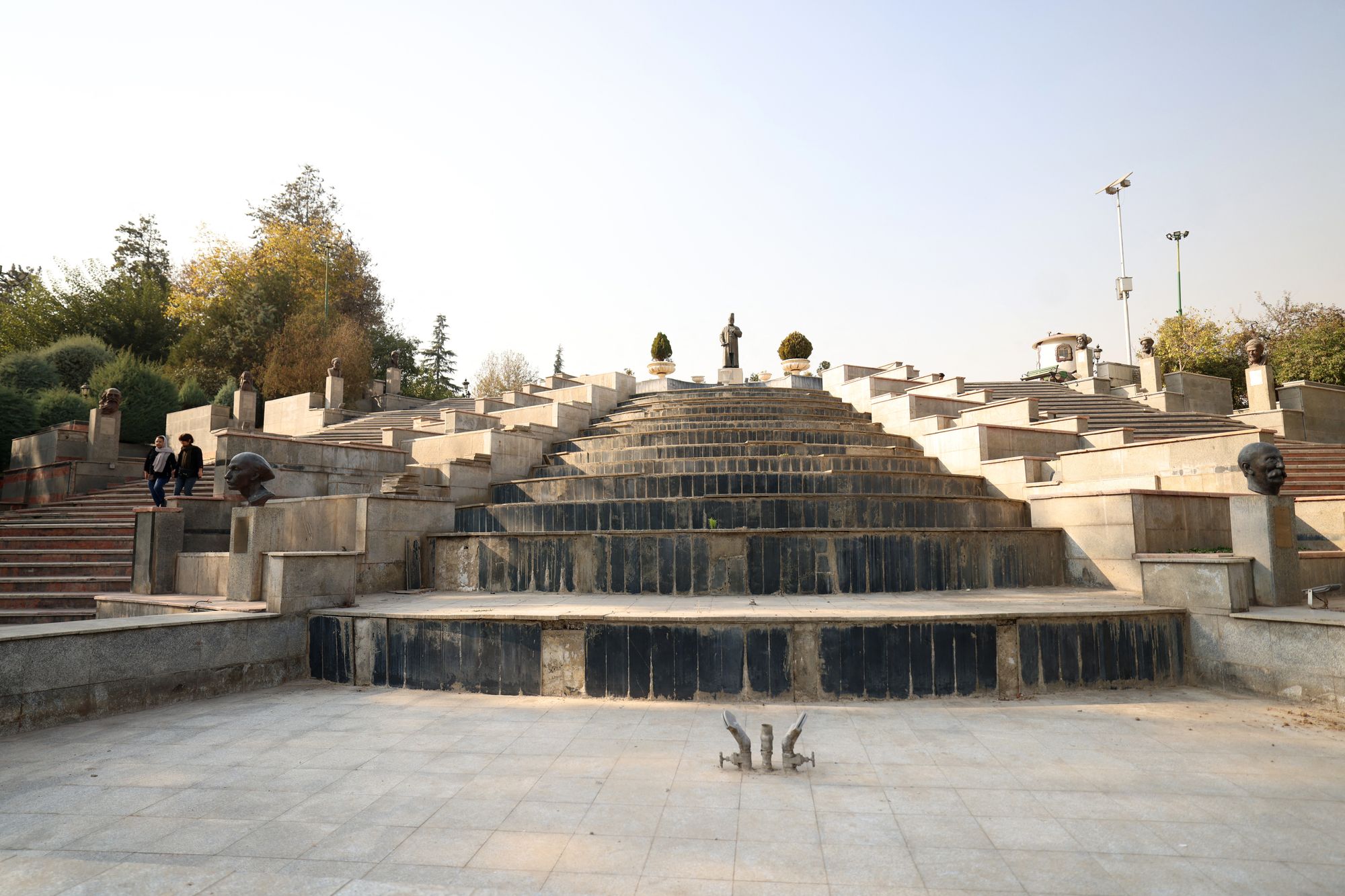 A dry water feature collects dust in Mellat Park