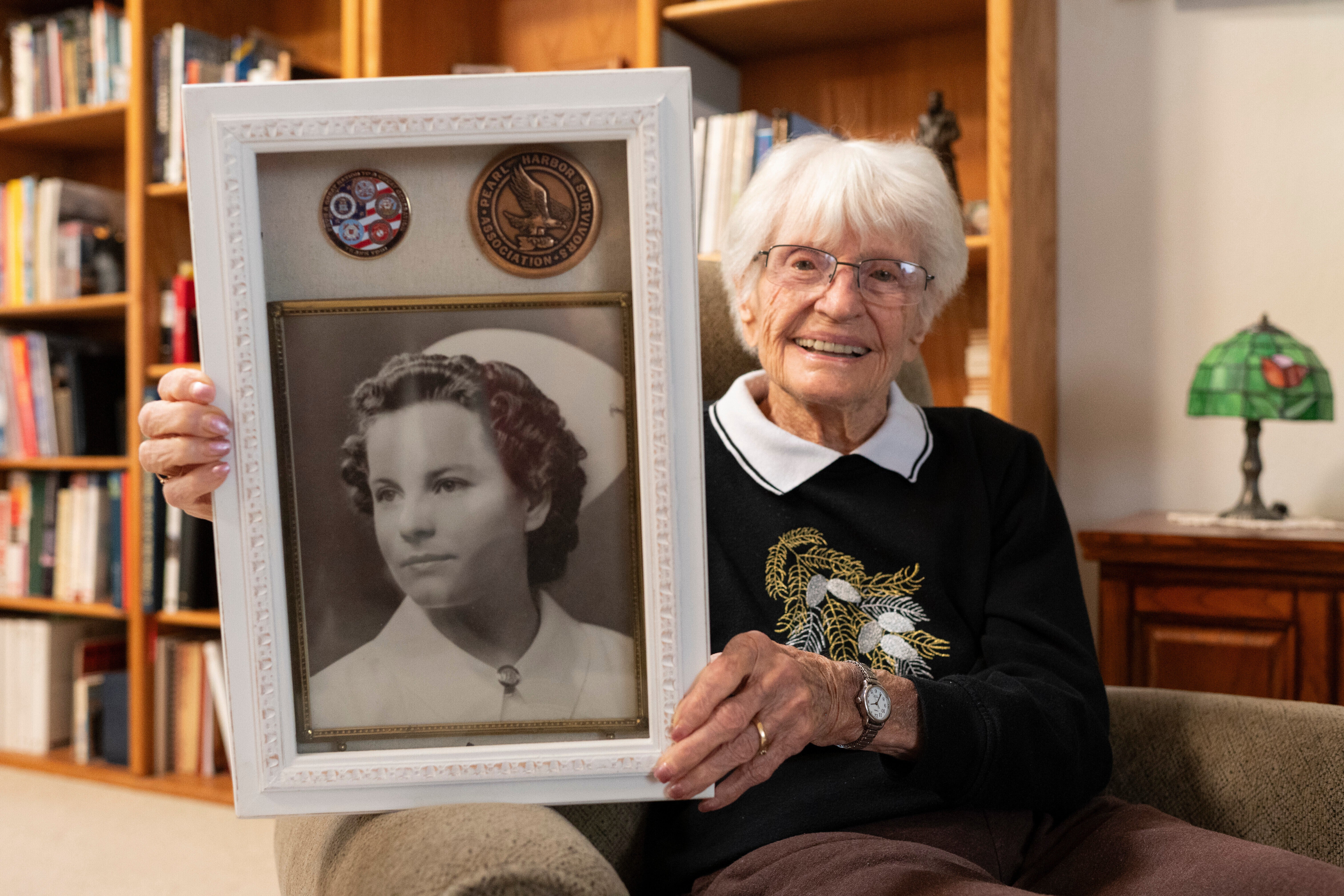 Alice Darrow shows a photo of herself from when she was a nurse during World War II, Thursday, Oct. 23, 2025, at her home in Danville, Calif.