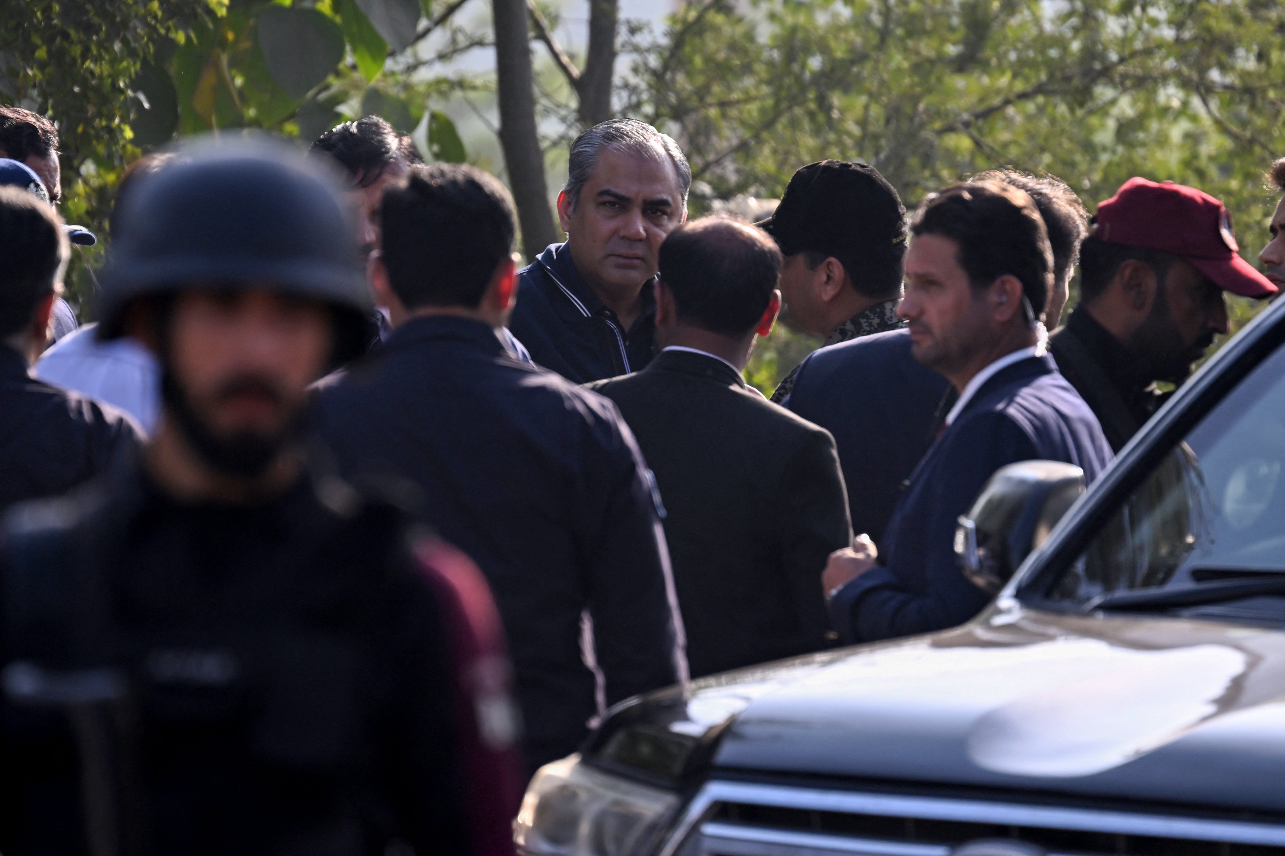 Pakistan’s federal interior minister Mohsin Naqvi (C) visits the suicide blast site in Islamabad on 11 November 2025. A suicide bombing outside district court buildings in a residential area of the Pakistani capital killed 12 people and wounded 27 on 11 November, the interior minister said