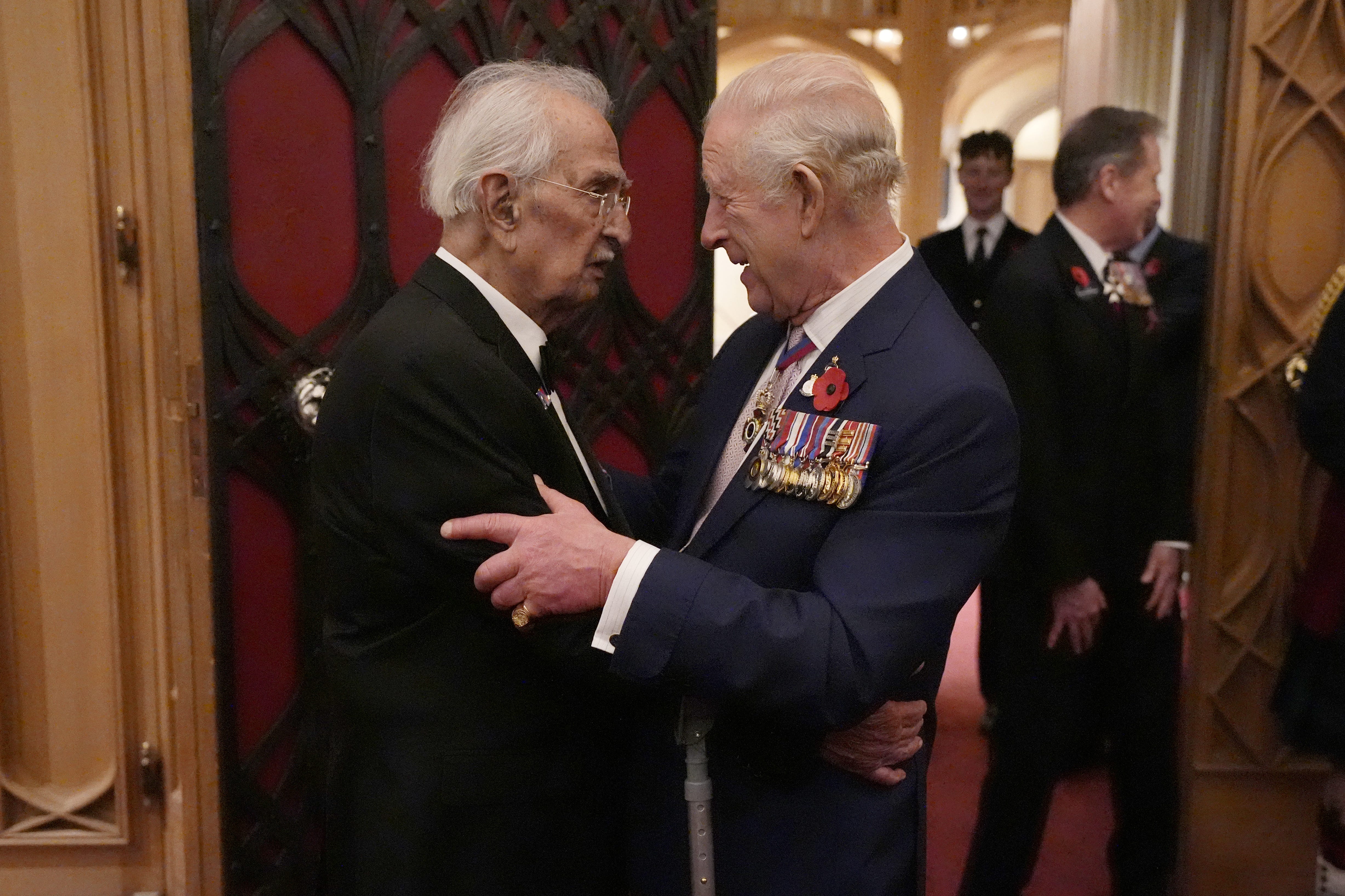 The King greeting Yavar Abbas at the reception for veterans at Windsor Castle (Andrew Matthews/PA)
