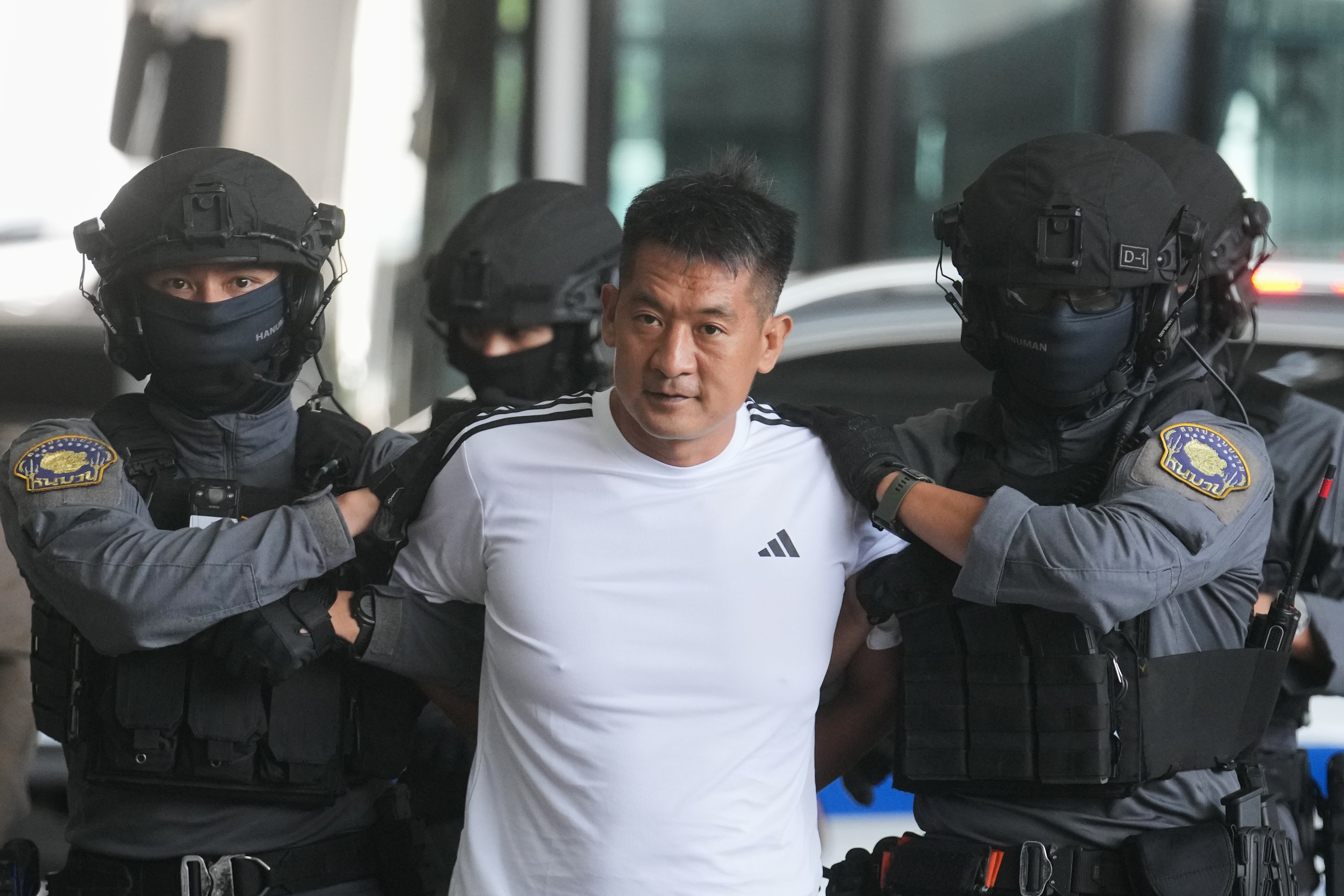 <p>She Zhijiang, an alleged transnational crime kingpin accused by Beijing of having run illegal online gambling operations, is escorted by police at Suvarnabhumi International Airport in Thailand’s Samut Prakarn province ahead of being extradited to China, Wednesday, 12 November 2025</p>
