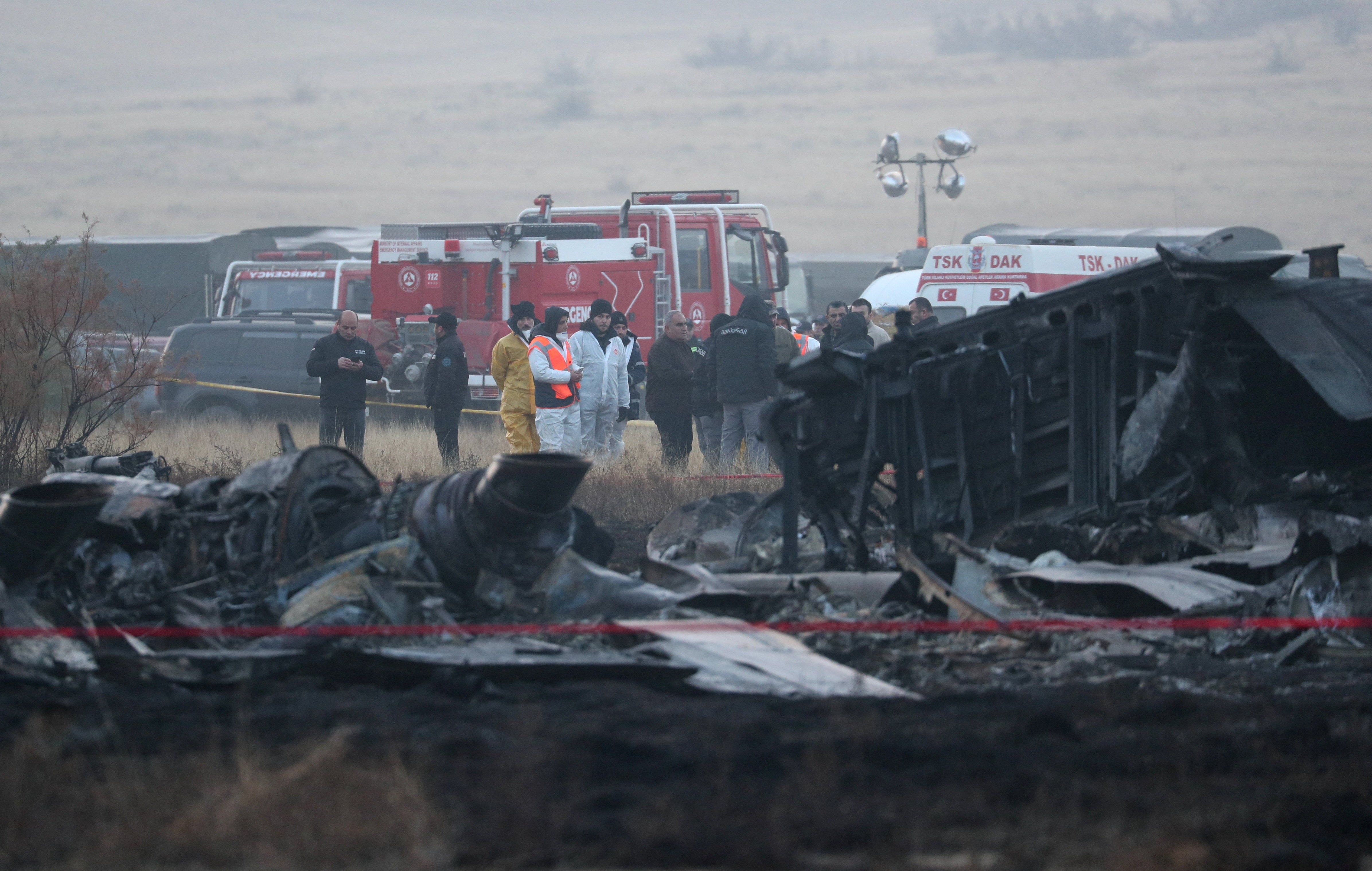Members of emergency services work at the site of the Turkish C-130 military cargo plane crash