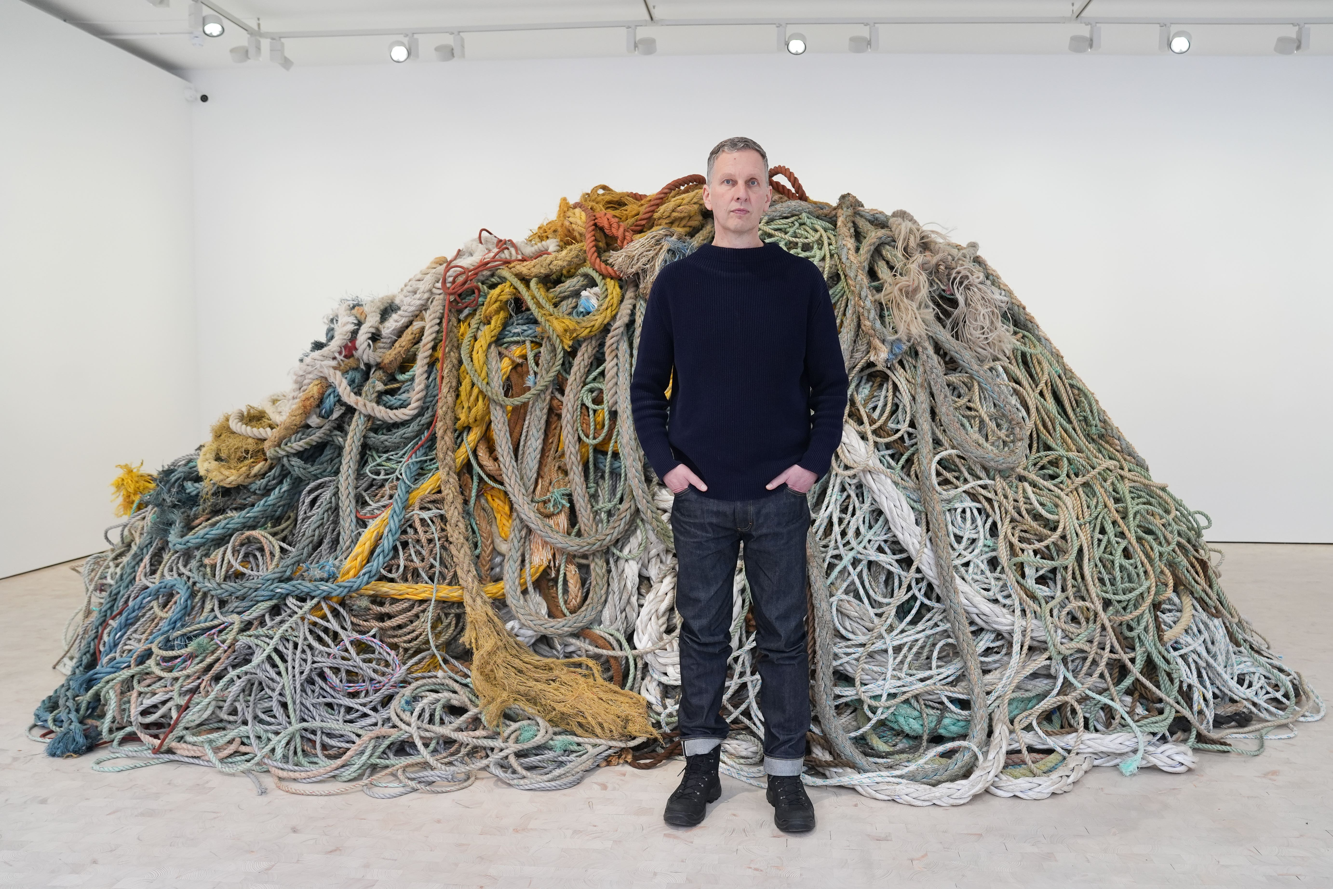 Artist David Shrigley with his new artwork ‘Exhibition of Old Rope’ at the Stephen Friedman Gallery in London
