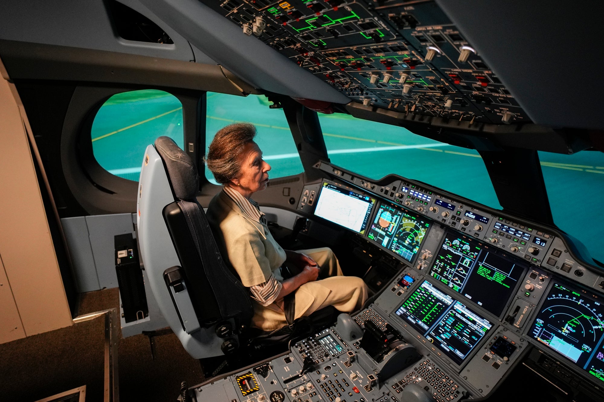 The Princess Royal takes part in a A350 flight simulation during a visit to the Airbus Asia Training Centre, currently the largest Airbus flight crew training centre in the world