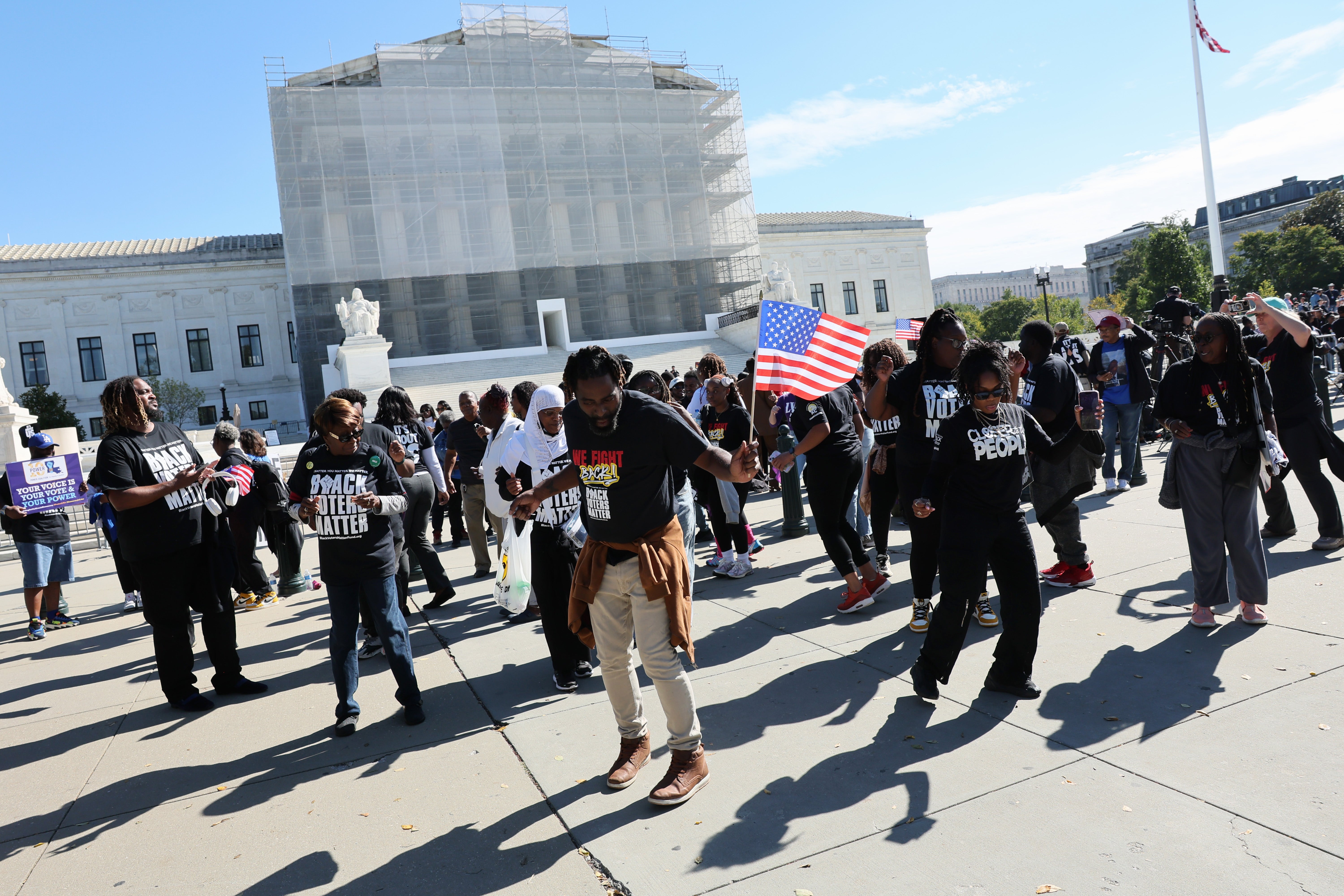 A group of people line dancing outside the Supreme Court of the United States