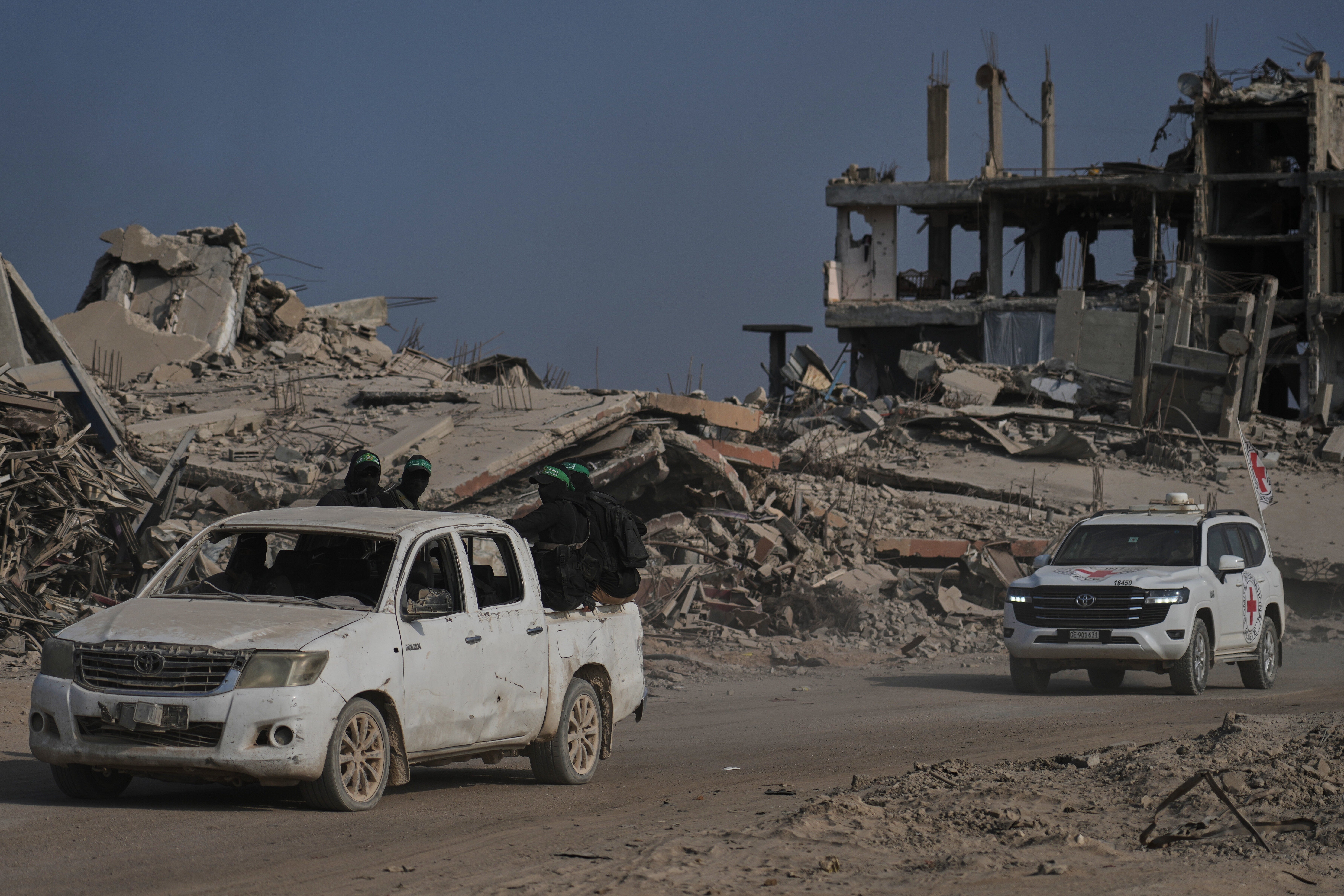 Hamas militants accompanied by members of the International Committee of the Red Cross head to the east of Gaza City to search for the bodies of hostages, on 13 November