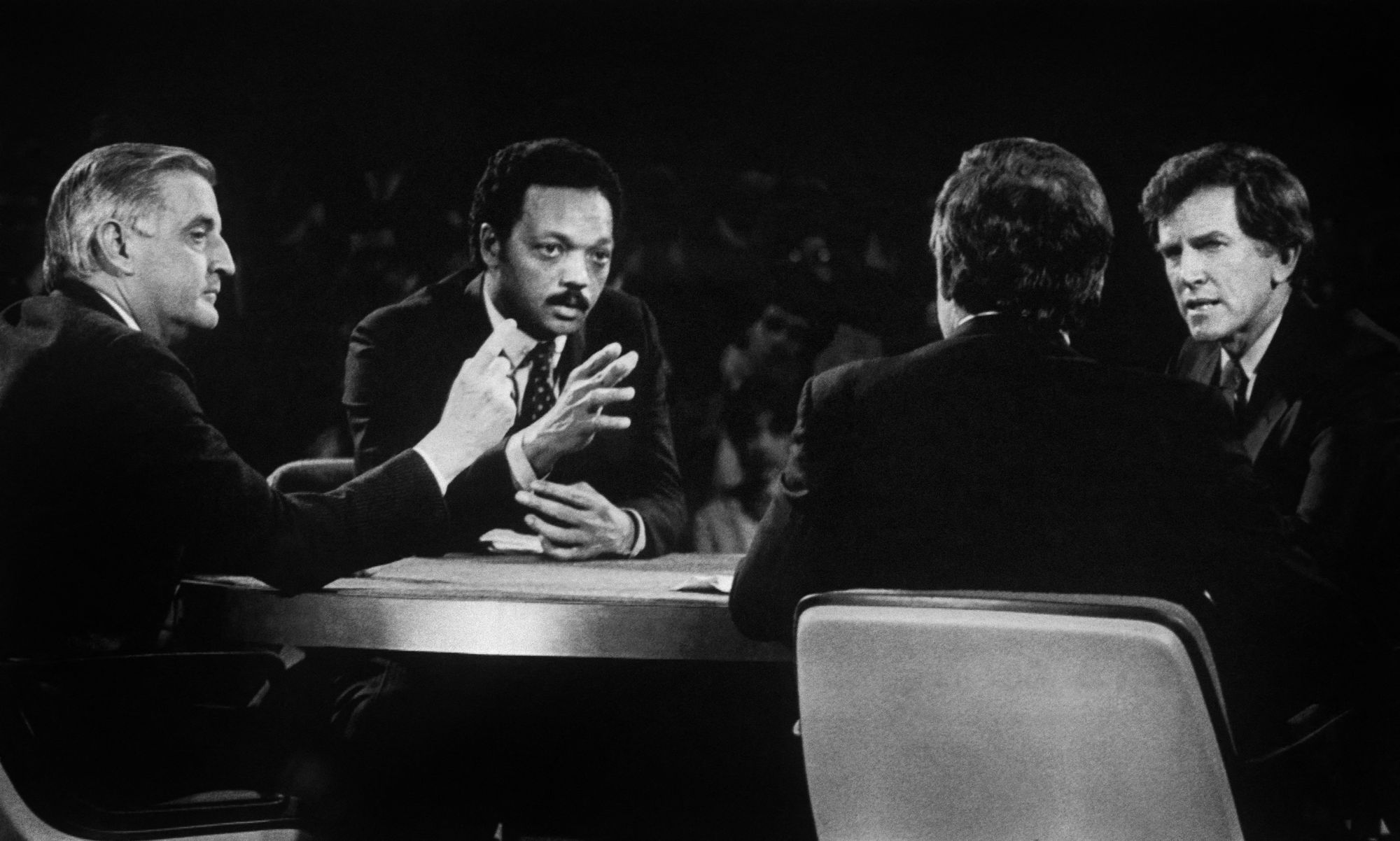 Jackson participating in the Democratic primary debate alongside Walter Mondale (left) on March 28, 1984
