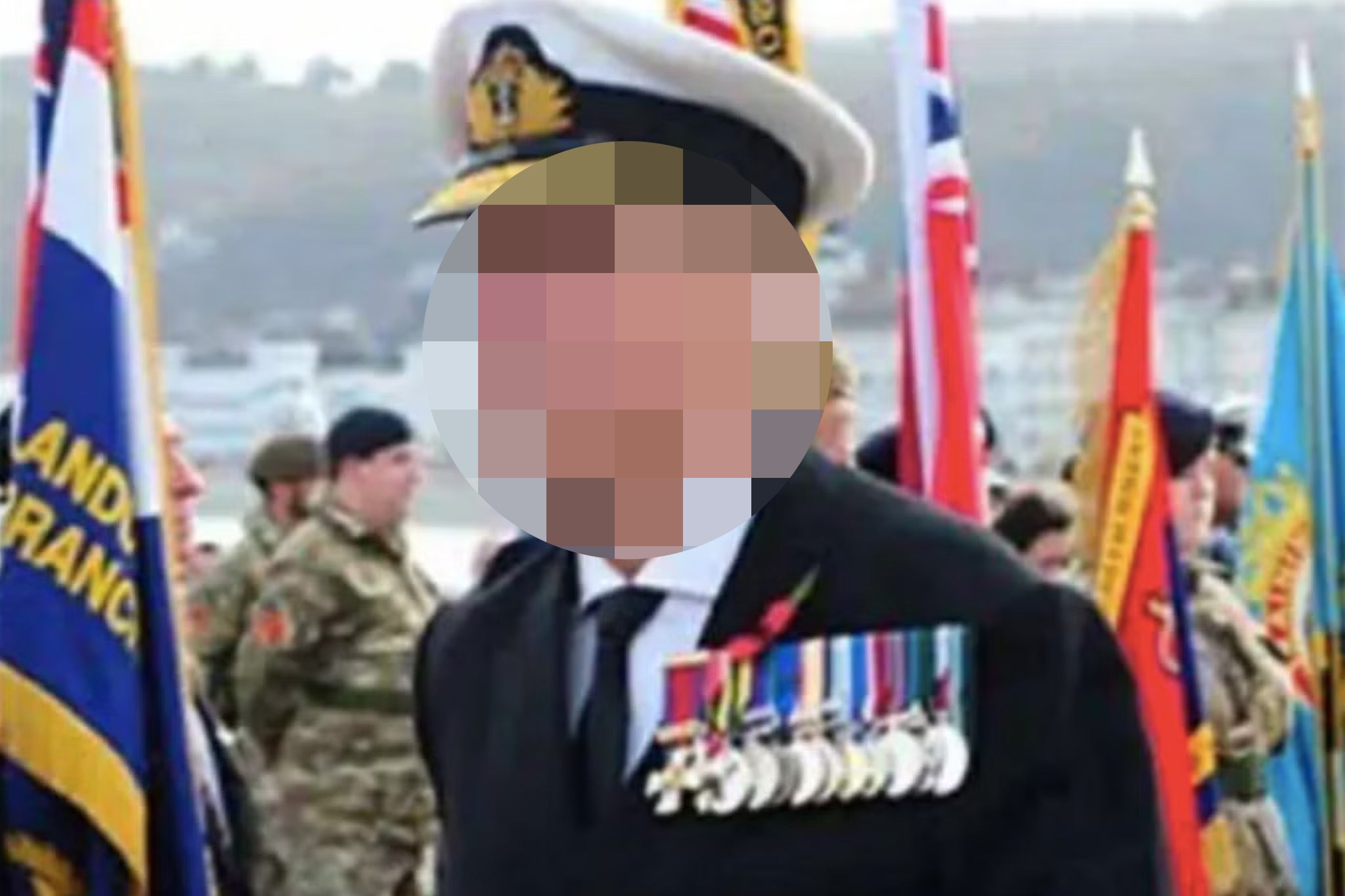 A man is seen wearing the uniform of a rear admiral along with 12 medals in Llandudno on Sunday