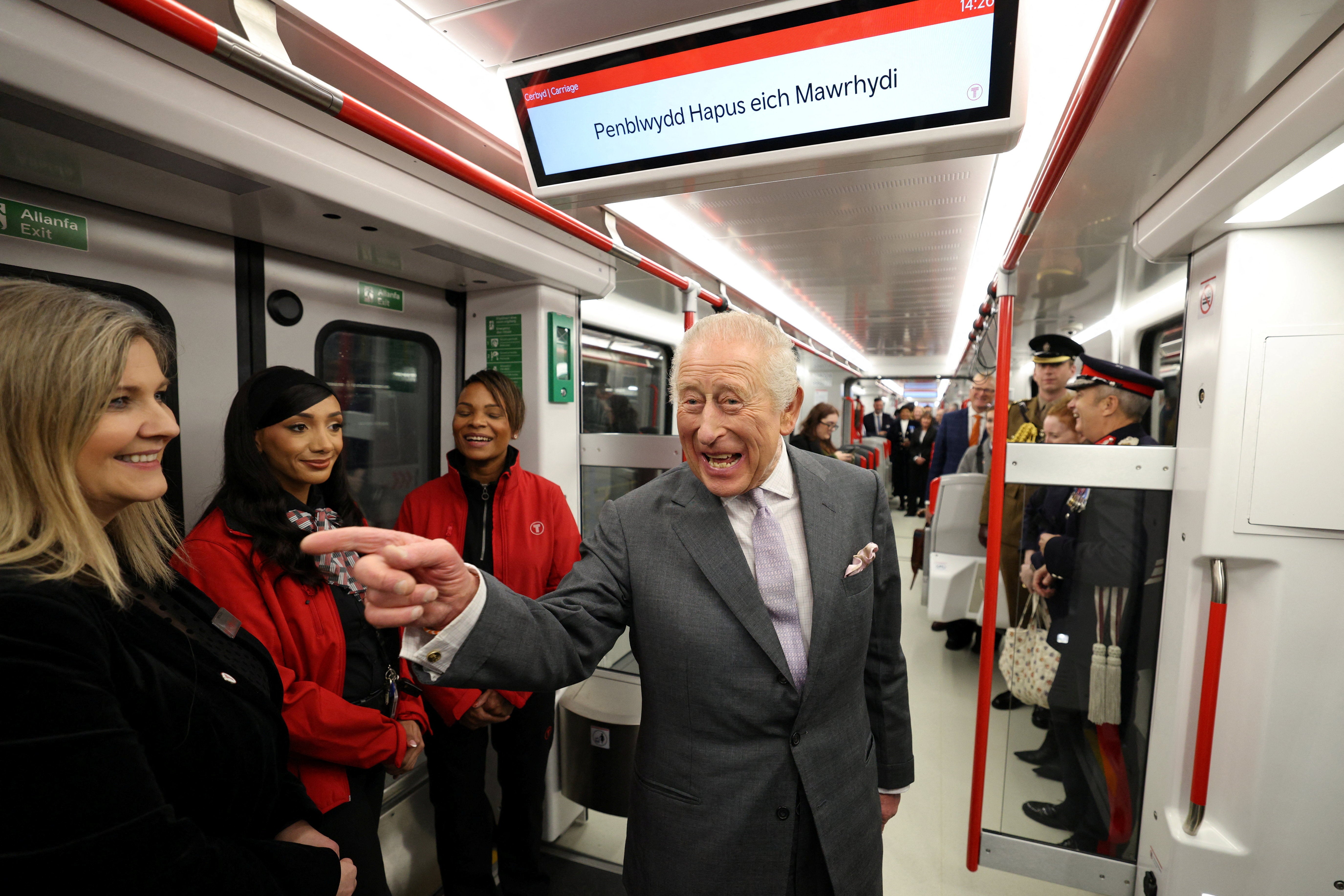 A birthday message is displayed on the screen as Britain's King Charles travels on a Stadler Class 398 Tram during a visit to officially open the South Wales Metro Depot