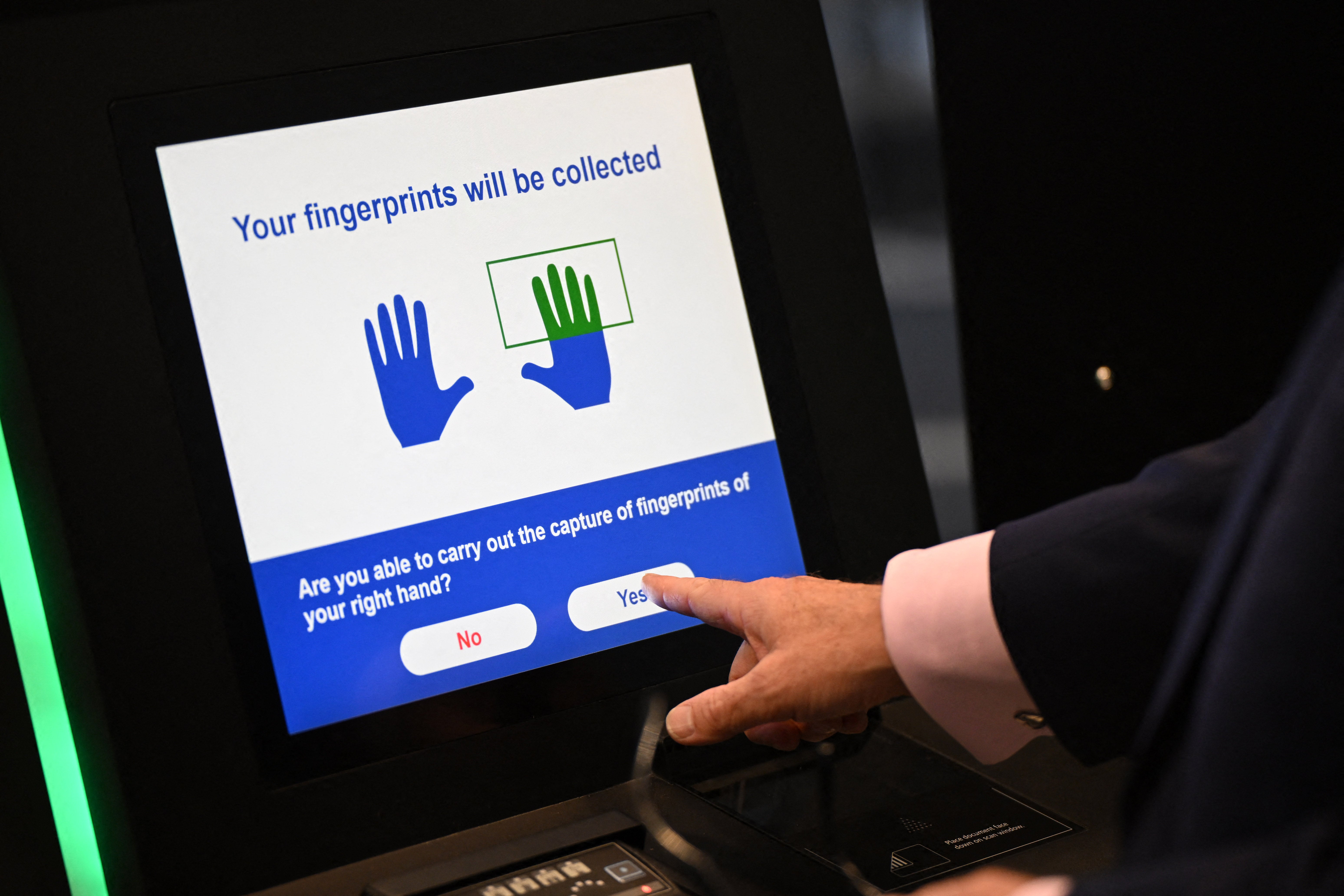 <p>A person uses the Automated European Union Entry/Exit System (EES) kiosk during a press preview on the rollout of the EU's new Entry-Exit System (EES) at Eurotunnel, south east England on September 23, 2025.</p>