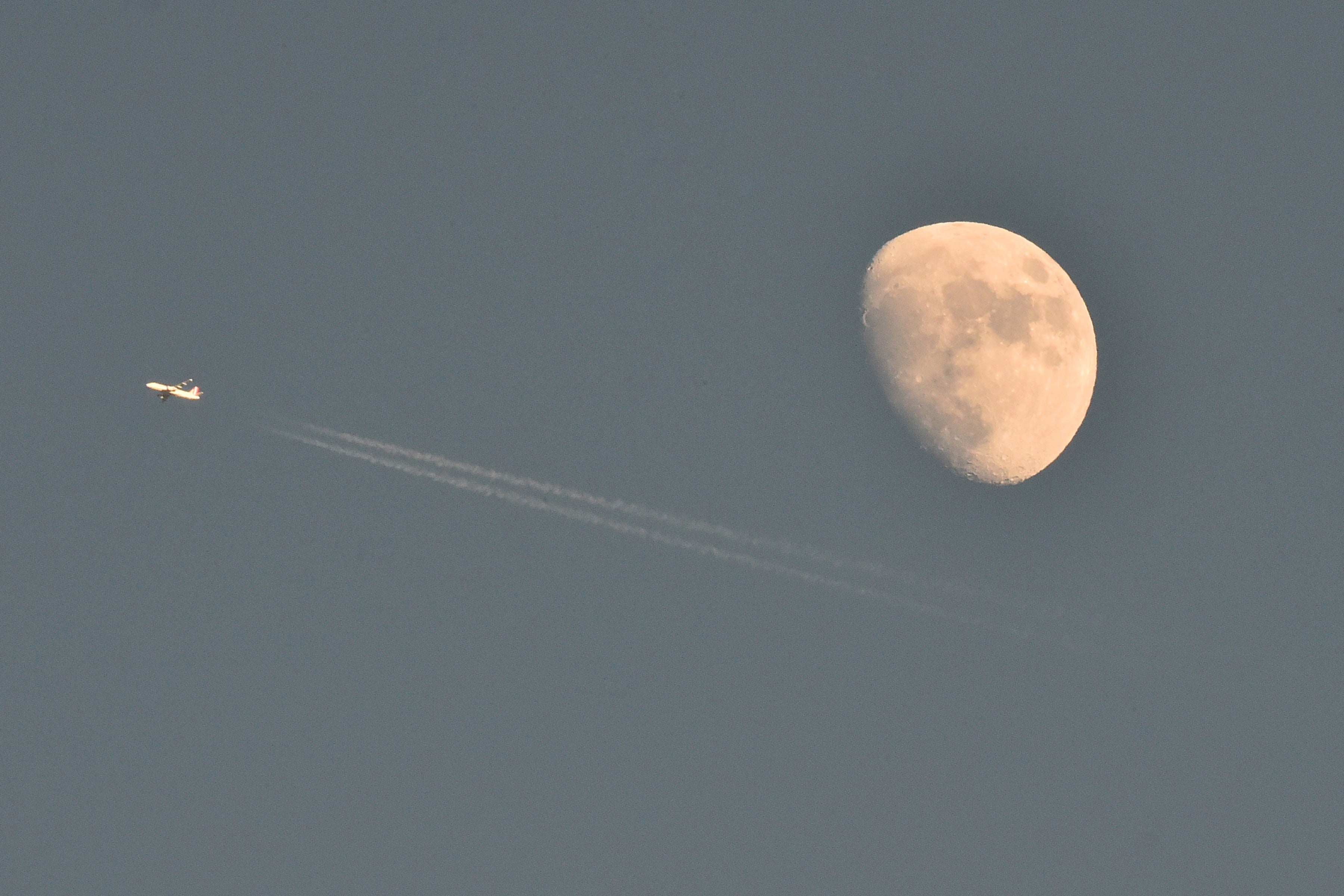 Chemtrails behind an aircraft in the sky
