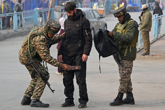 <p>Indian paramilitary troopers frisk a pedestrian during a random search in Srinagar after blast in Delhi</p>
