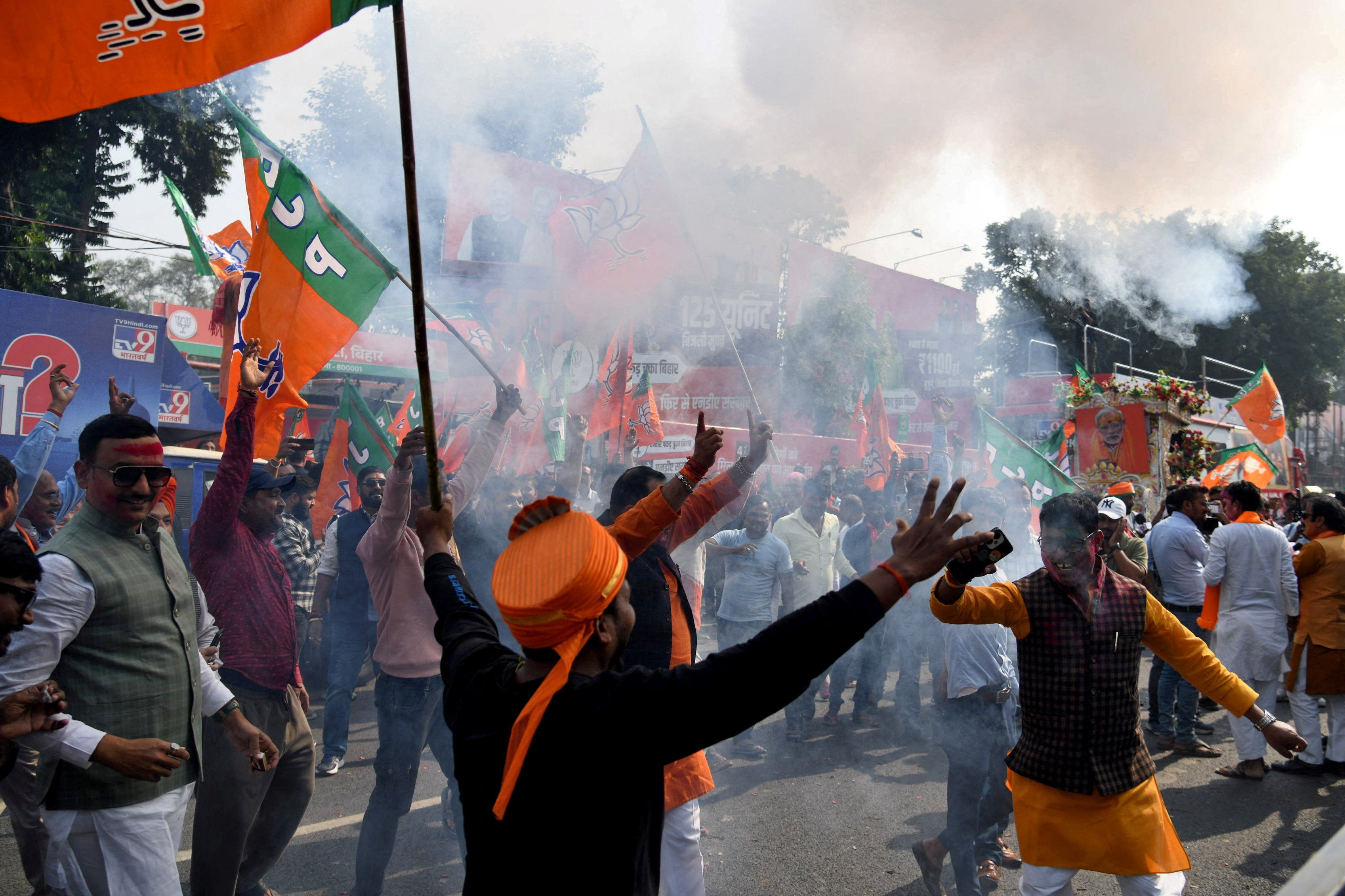 BJP supporters celebrate as early trends show the ruling National Democratic Alliance leading in the Bihar assembly election in Patna