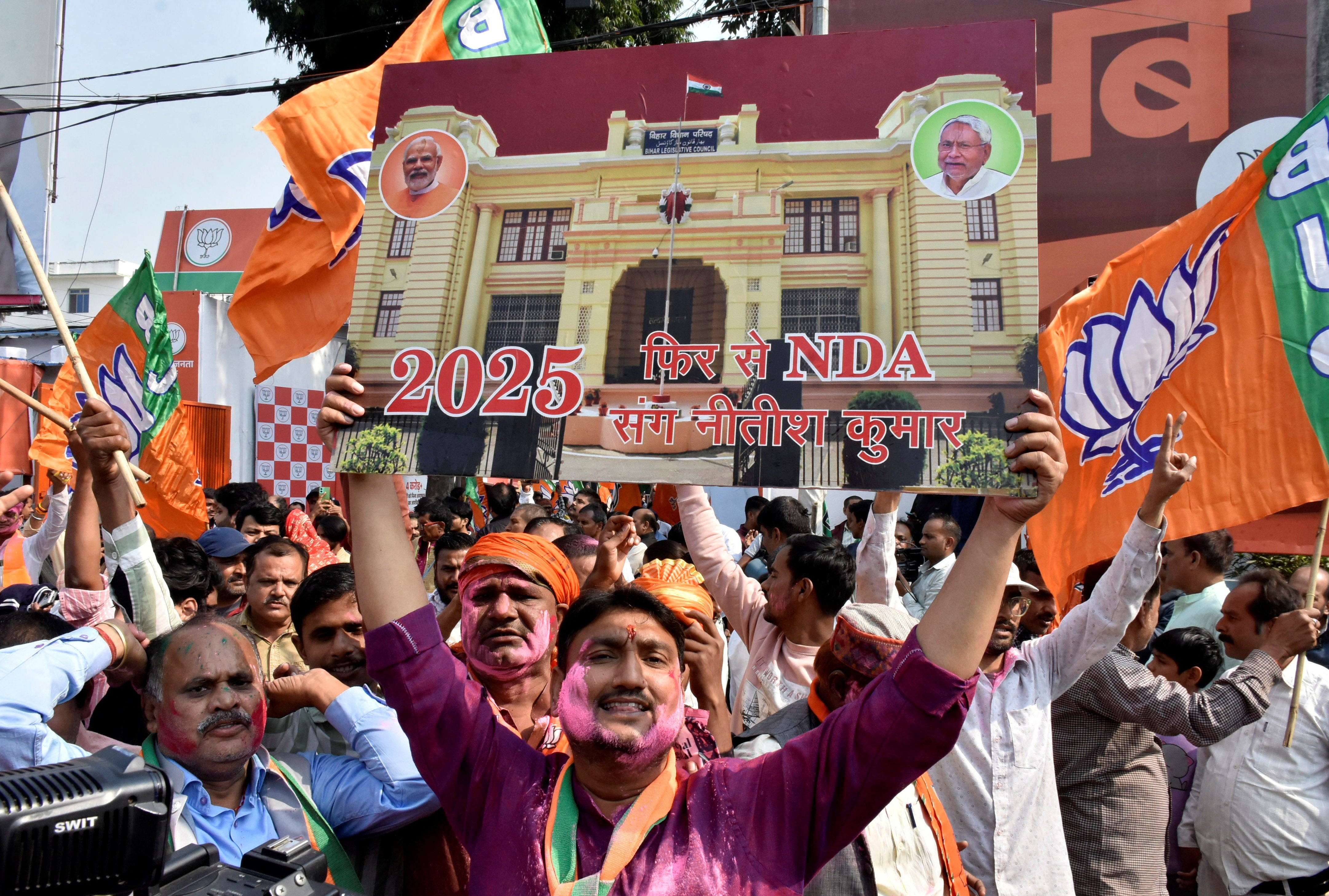 BJP supporters celebrate as early trends show the ruling National Democratic Alliance leading in the Bihar state assembly election in Patna