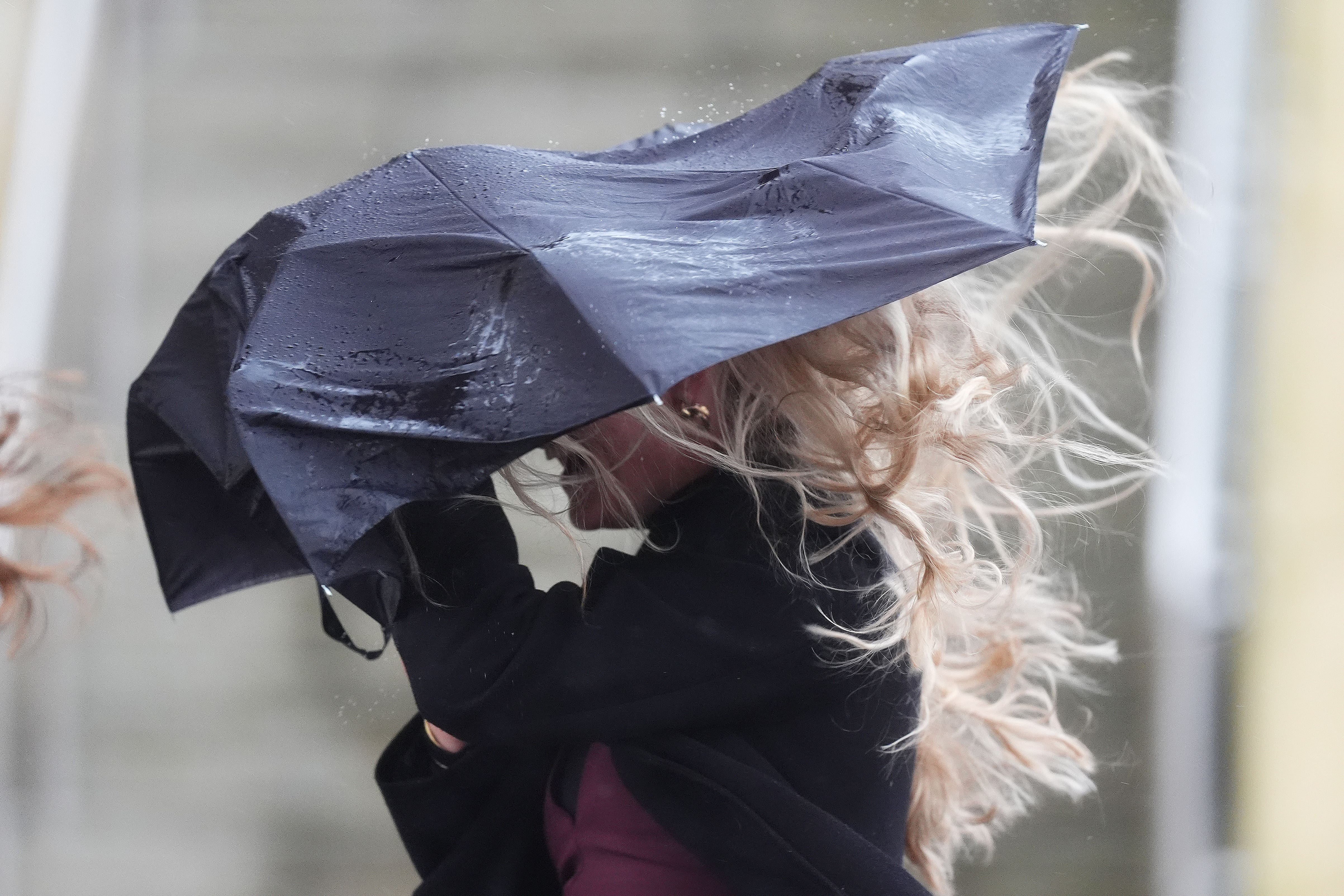 A racegoer struggles at Cheltenham Racecourse on Friday (Mike Egerton/PA)