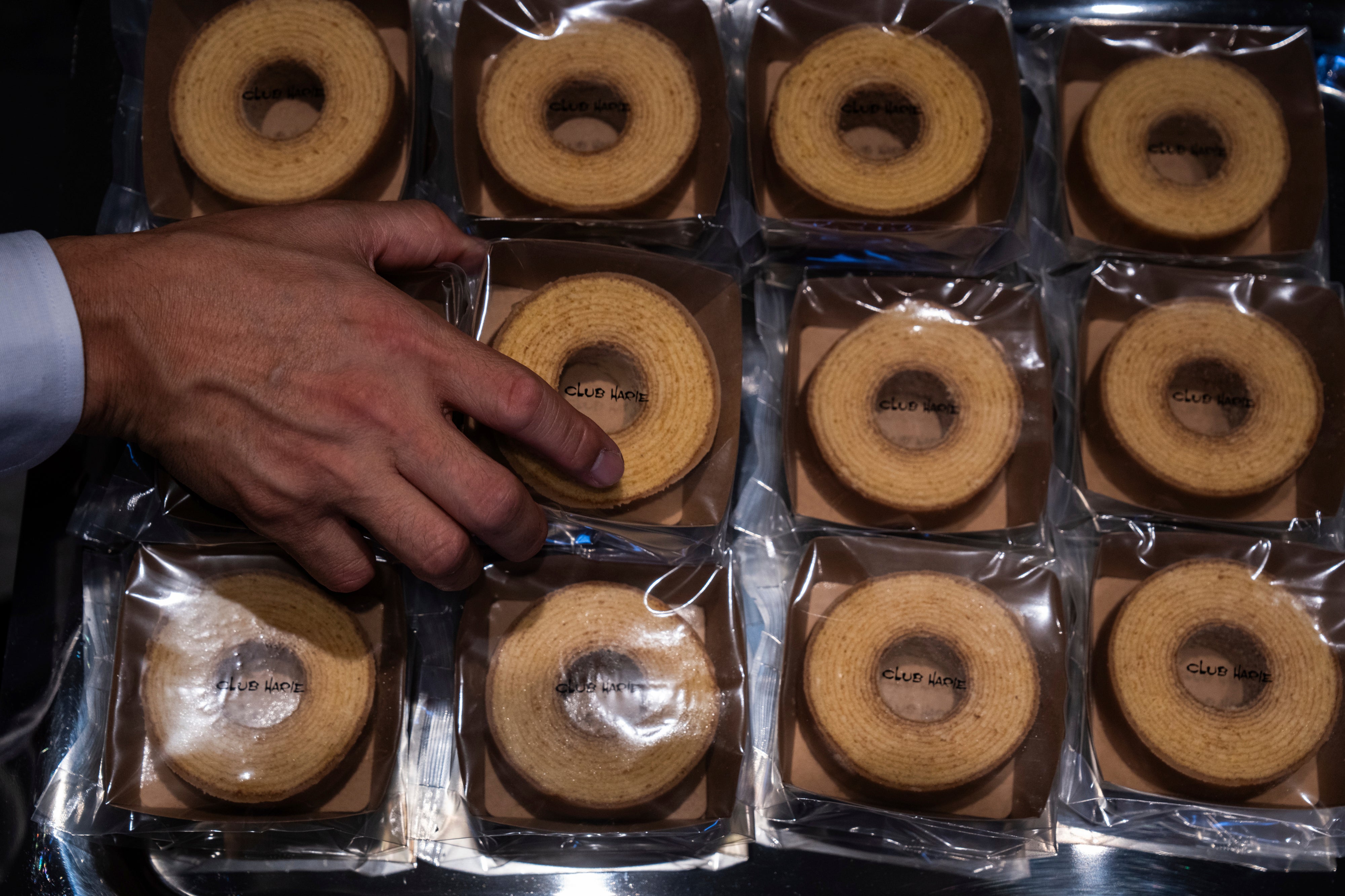 <p>A vendor sorts sweets at a Baumkuchen store on its opening day in Tokyo</p>