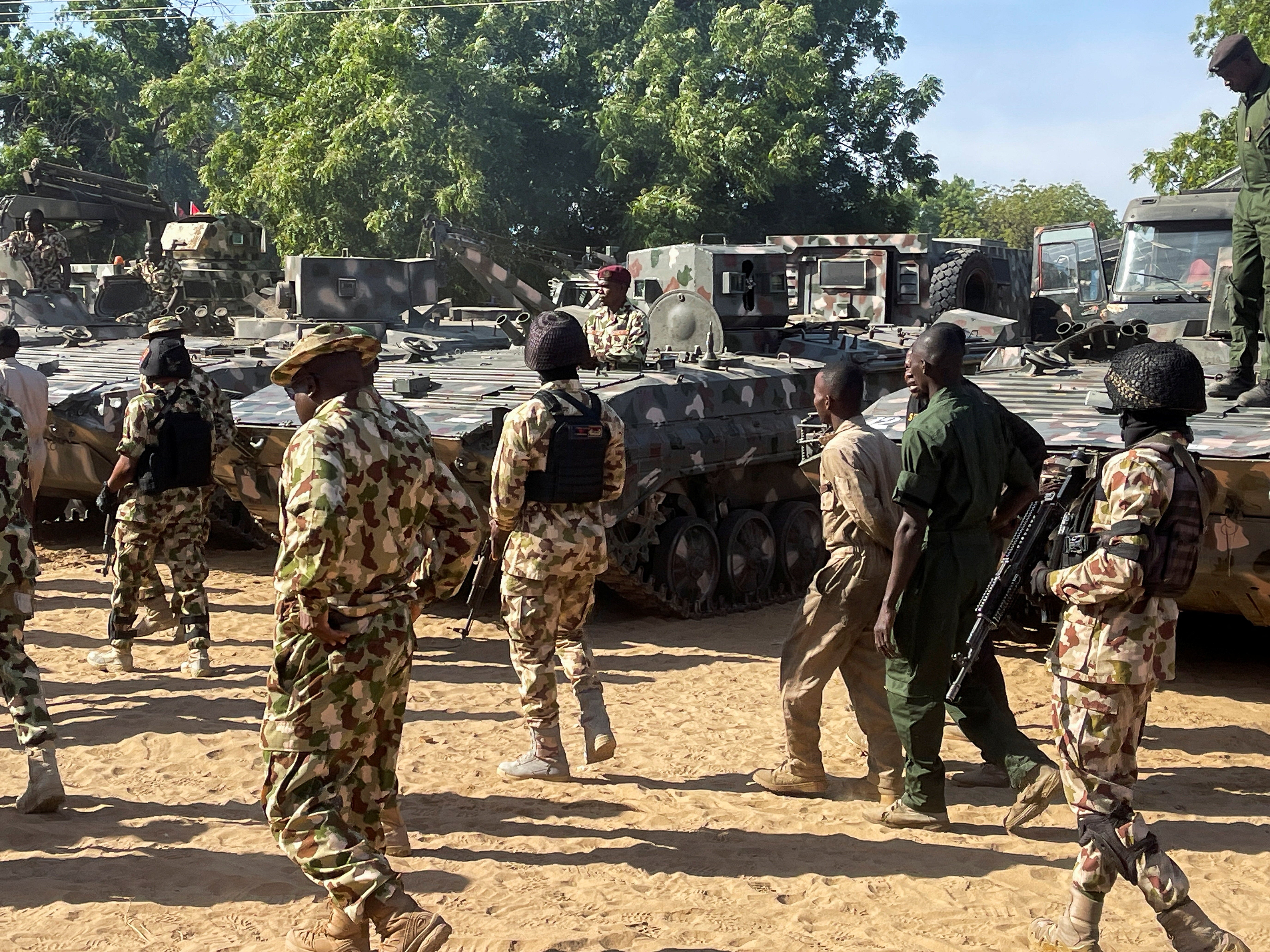 Nigerian soldiers walks past military tanks prepared for deployment during a tour of the Theatre Command Operation Lafiya Dole by Nigeria's Chief of Army Staff at Maimalari Cantonment in Maiduguri, Borno State, Nigeria, November 7, 2025