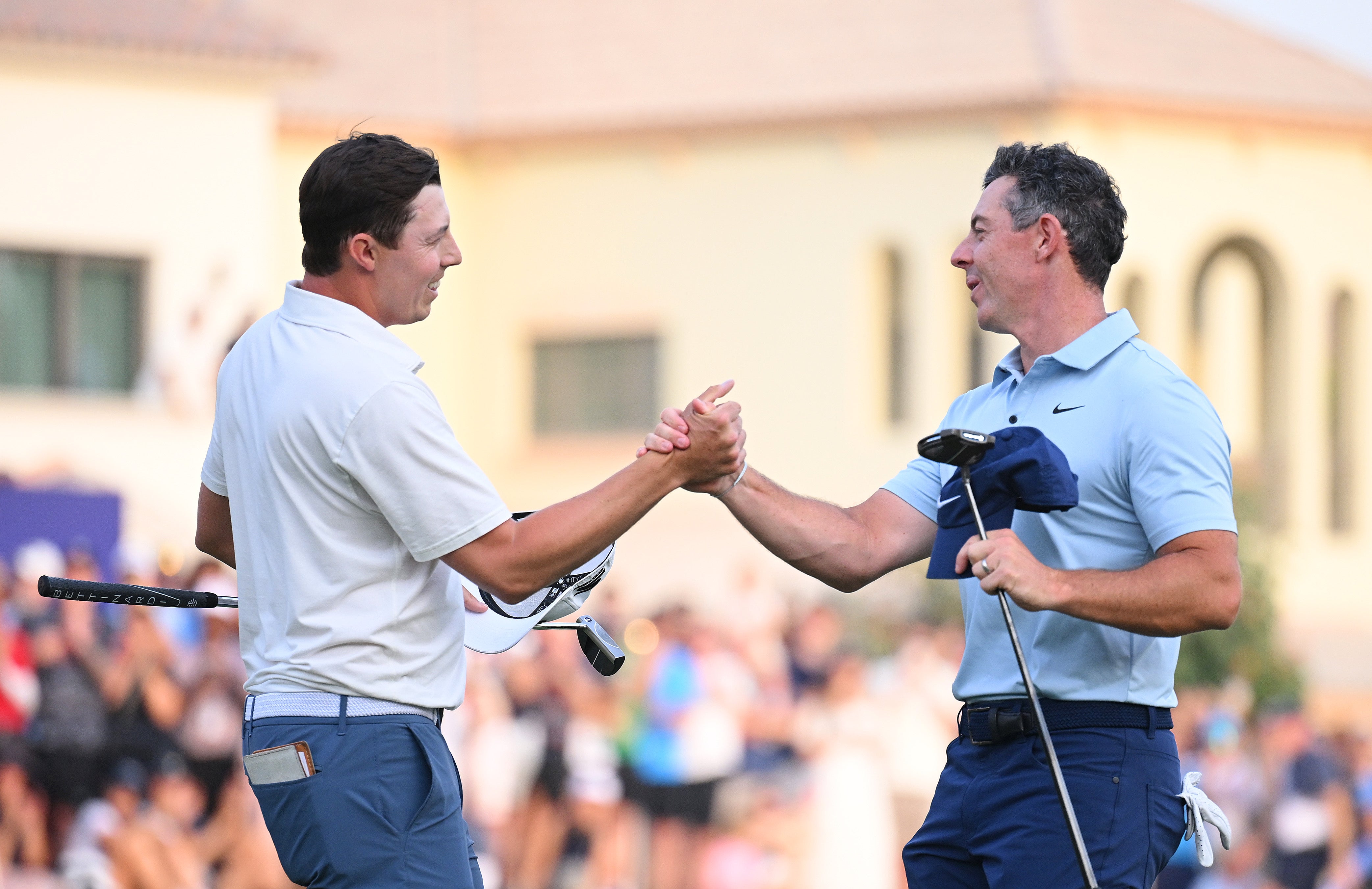 Matt Fitzpatrick of England and Rory McIlroy of Northern Ireland shake hands on the 18th green following the play-off