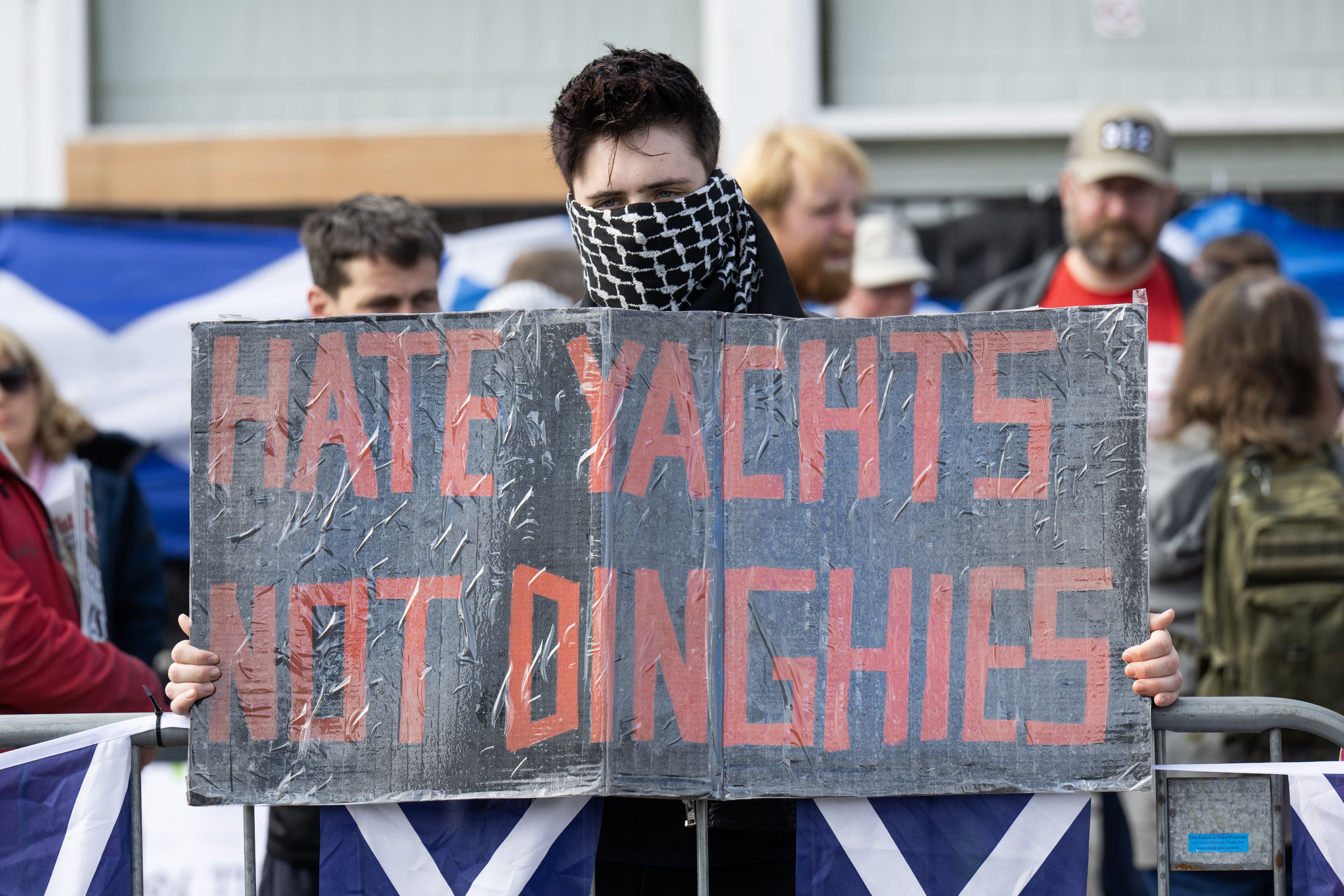 People take part in a Stand Up To Racism counter protest during a protest by people attending a Save Our Future & Our Kids Futures protest outside the Cladhan Hotel in Falkirk (Lesley Martin/PA)
