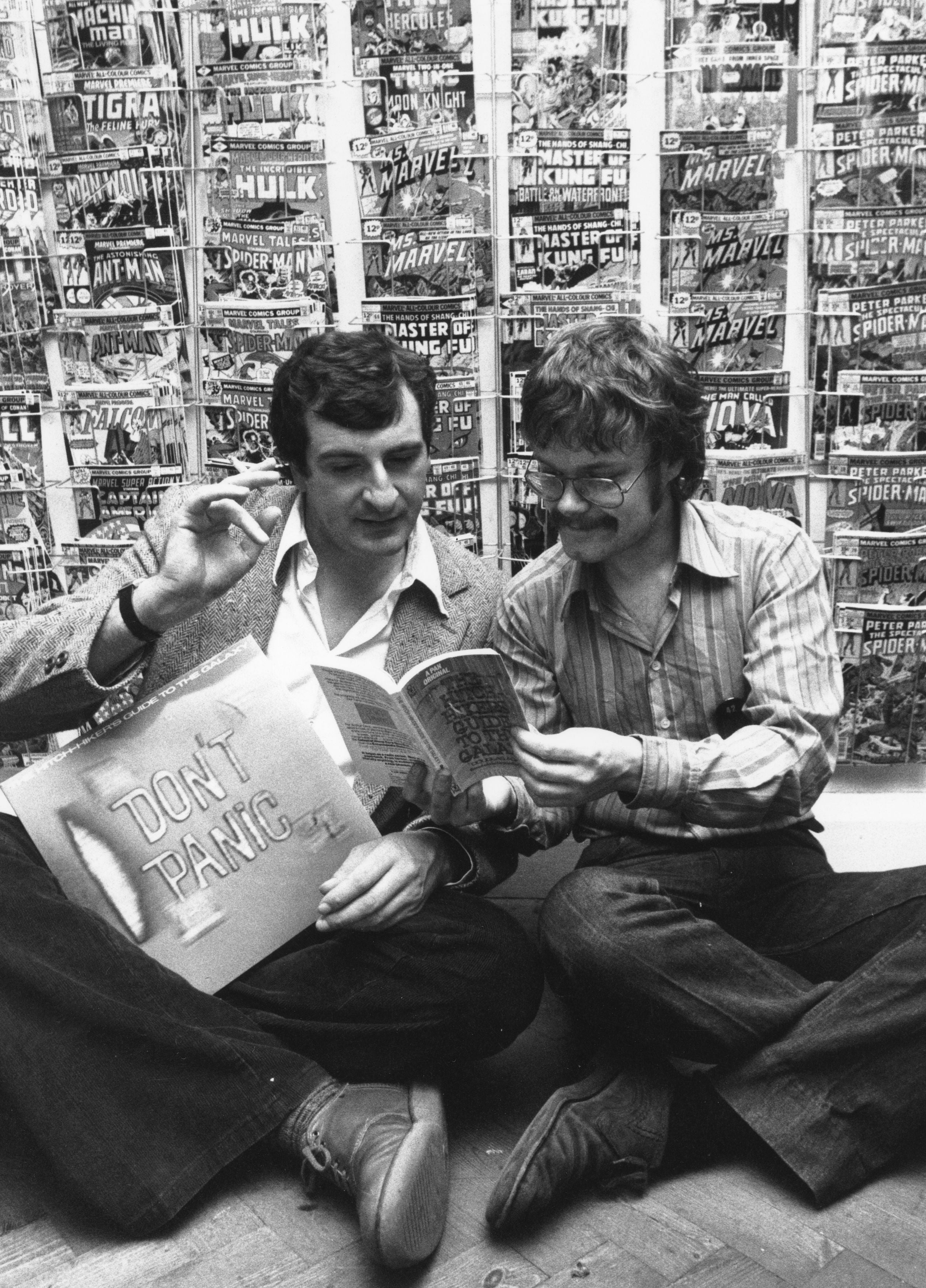Douglas Adams (left) pours through a copy of ‘The Hitchhiker’s Guide to the Galaxy’ in 1979