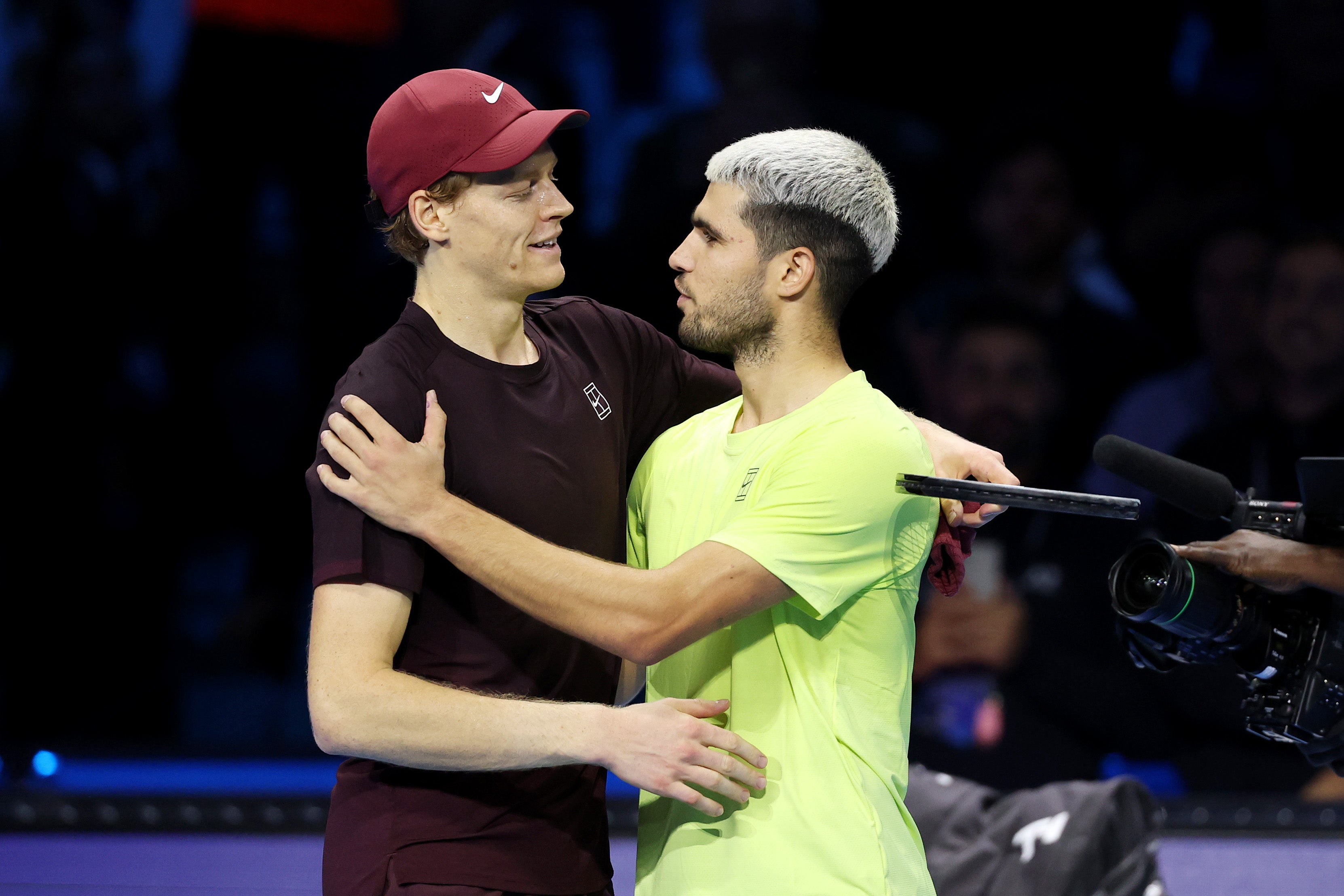 Jannik Sinner and Carlos Alcaraz embrace after the ATP Finals in Turin