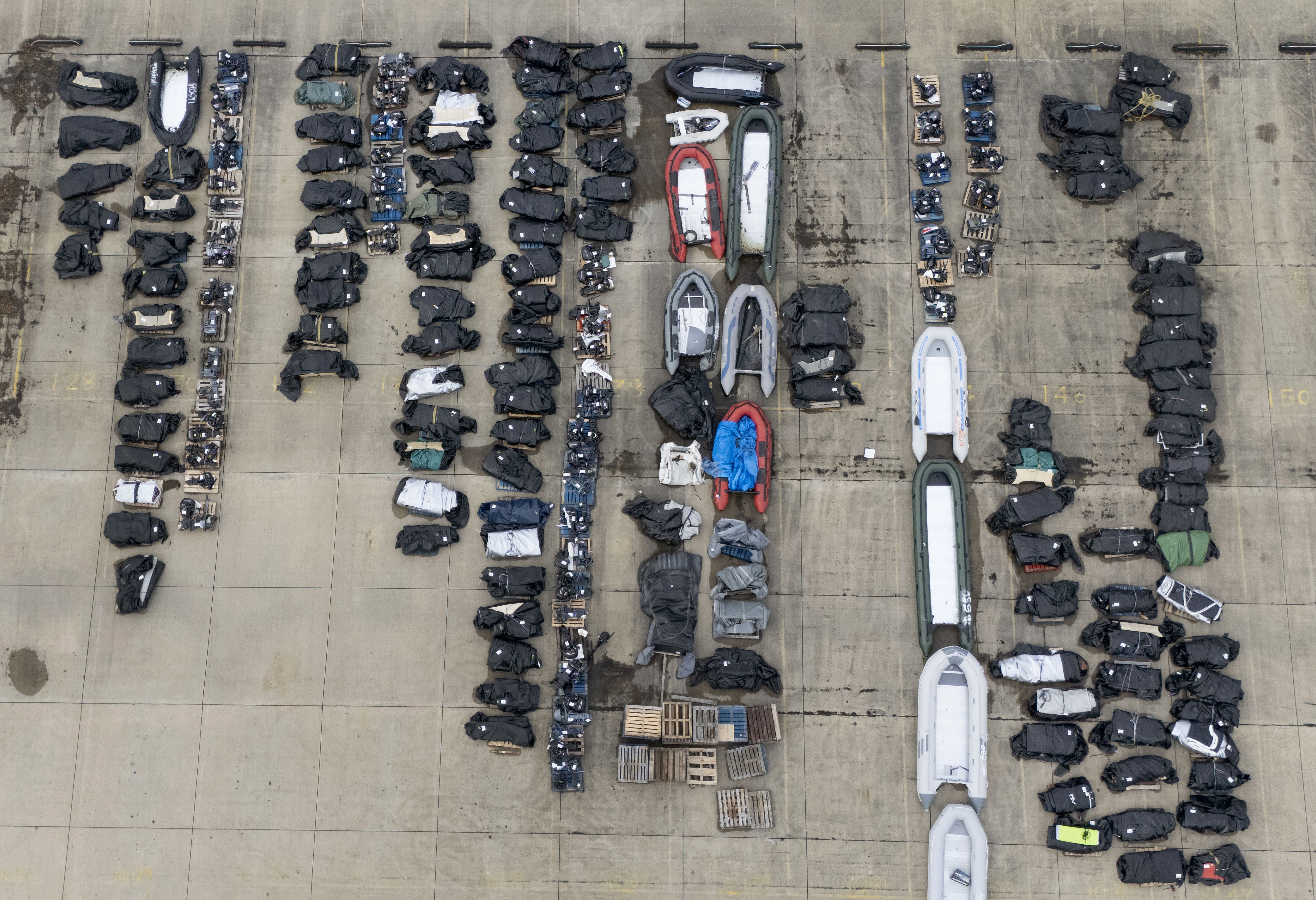 A view of small boats and outboard motors used by people thought to be migrants to cross the Channel from France at a warehouse facility in Dover, Kent