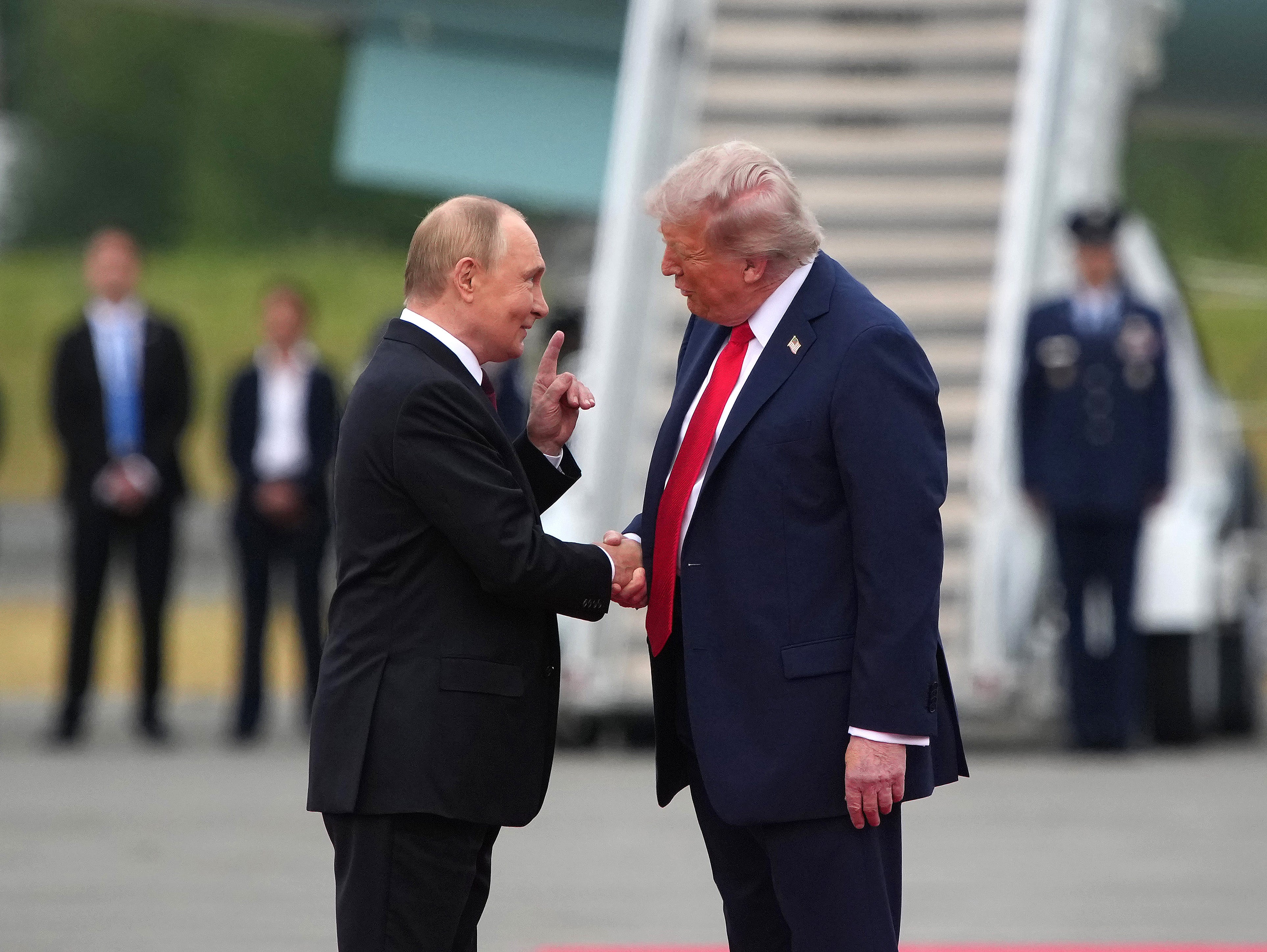 Donald Trump greets Vladimir Putin in Alaska in August