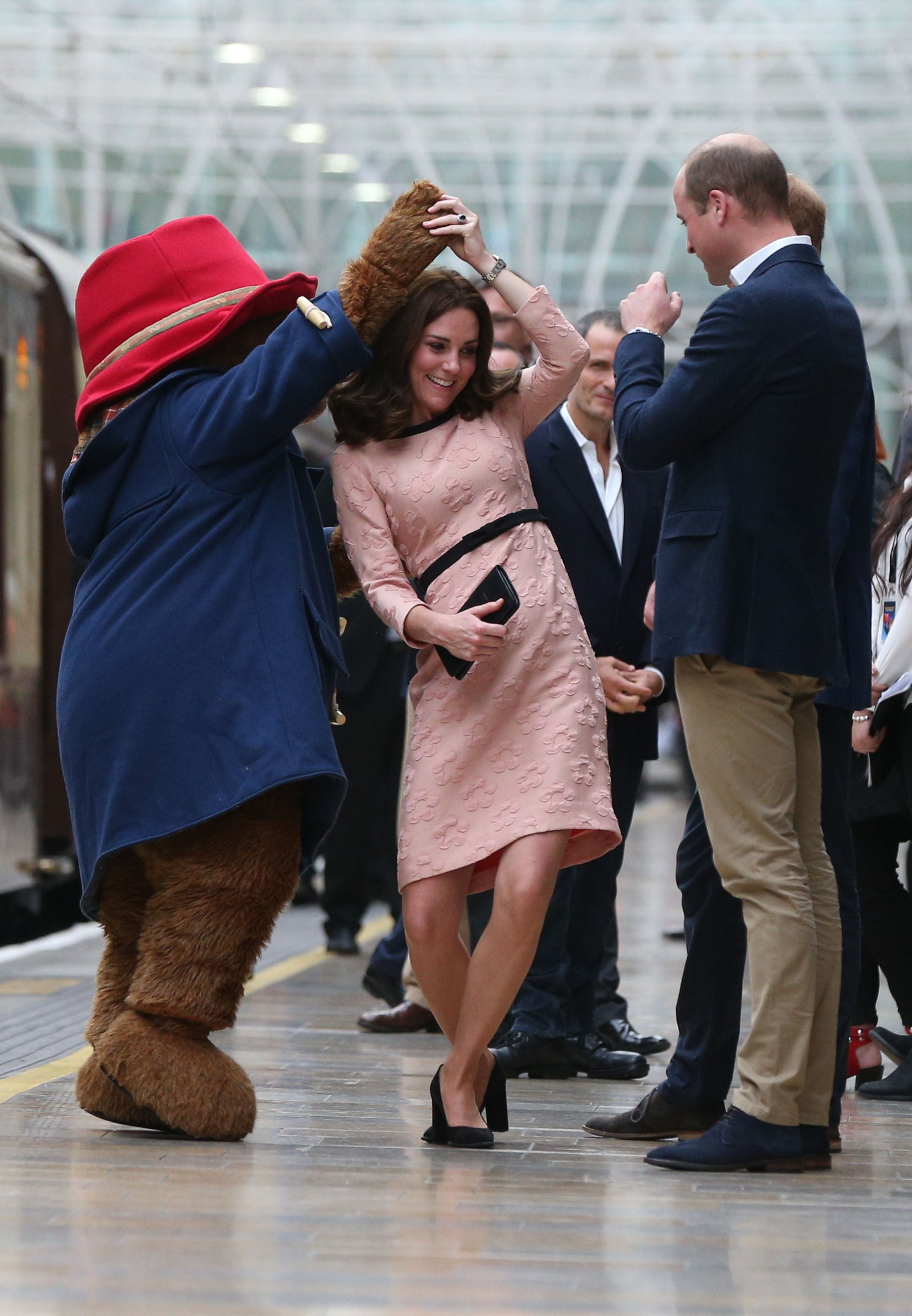 Kate dances with Paddington Bear on Platform One at Paddington Station in 2017