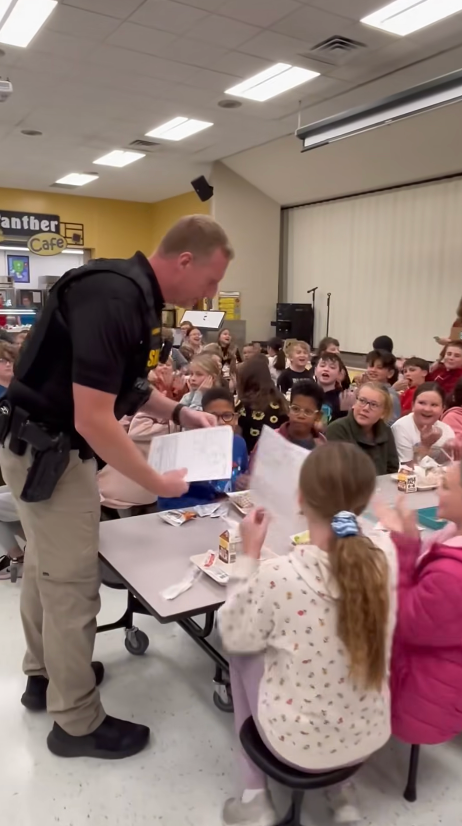 Officers could be seen in the clip jokingly handing out “tickets” to students