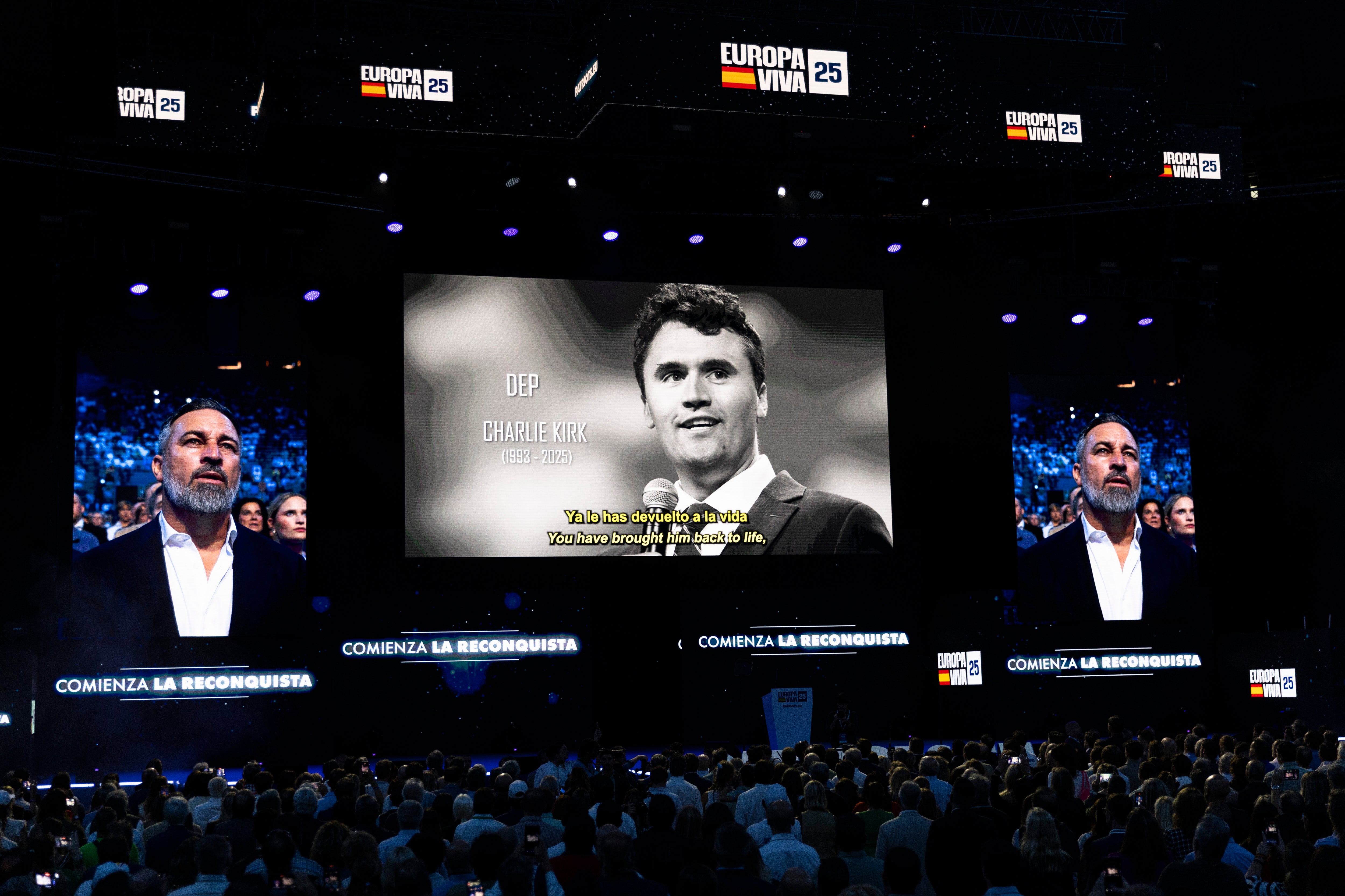 Santiago Abascal, leader of the Spanish right-wing party Vox, is seen on screens alongside an image of Charlie Kirk, who was killed four days previously, at a Patriots for Europe rally at Palacio de Vistalegre in Madrid on 14 September