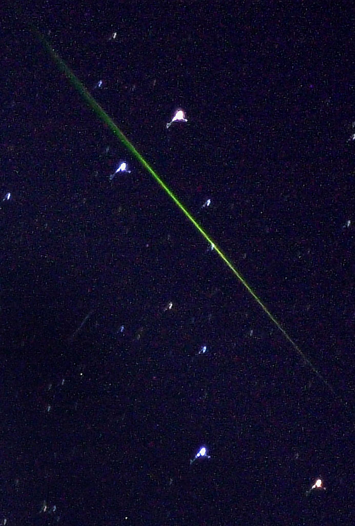 SHERBORN, UNITED STATES: The green streak of a meteor seen in the southern sky of New England photographed in Sherborn, Massachusetts early 18 November, 2001 and was one of thousands that entered the earth's atmosphere during a major meteor shower. The shower, which occurs over several days every mid-November, is called the Leonids because it appears to come from the constellation of Leo