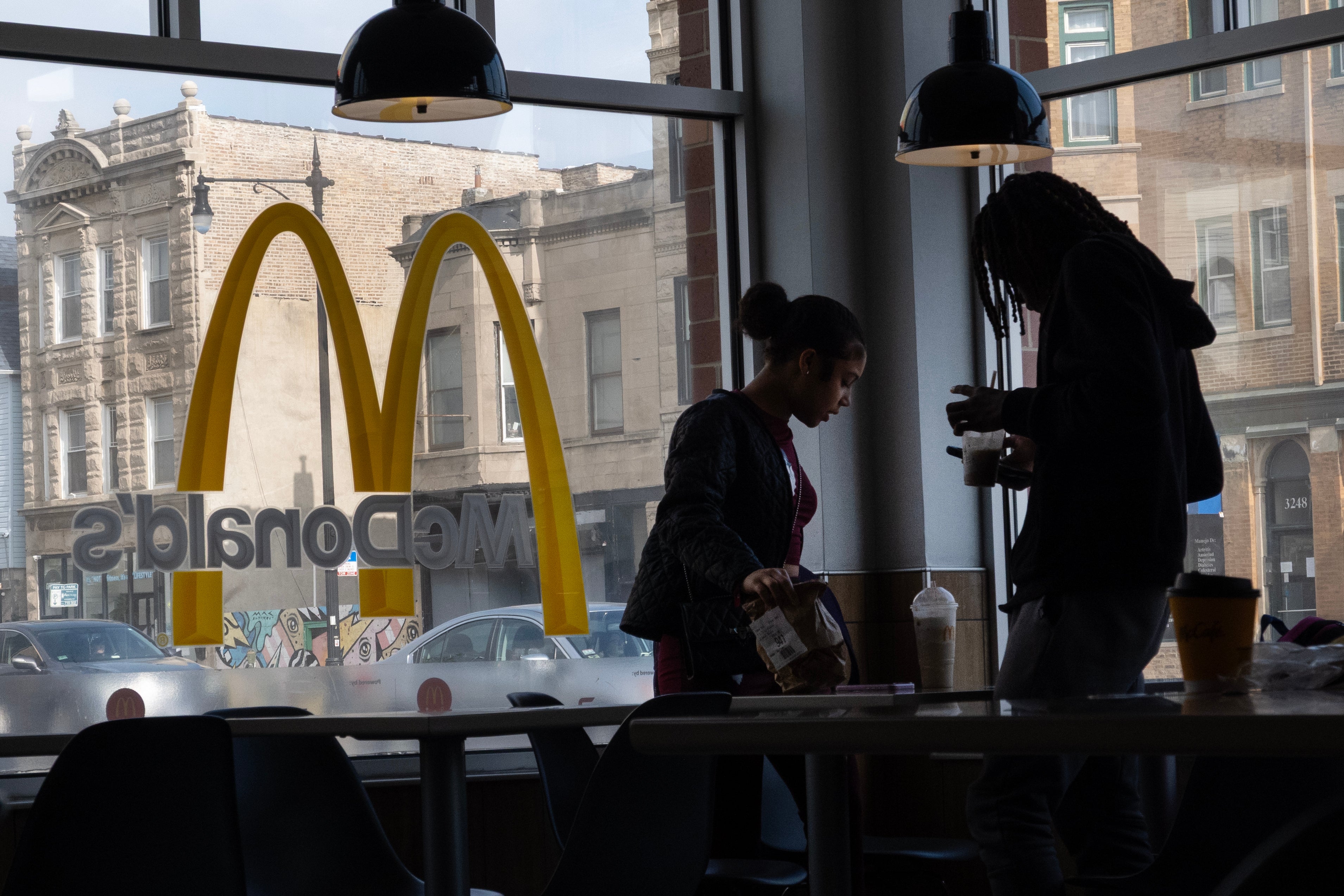 Economists said the drop in lower-income customers buying fast food reflects a larger trend: Wealthier Americans are spending more freely, while those on smaller budgets are tightening the purse strings.