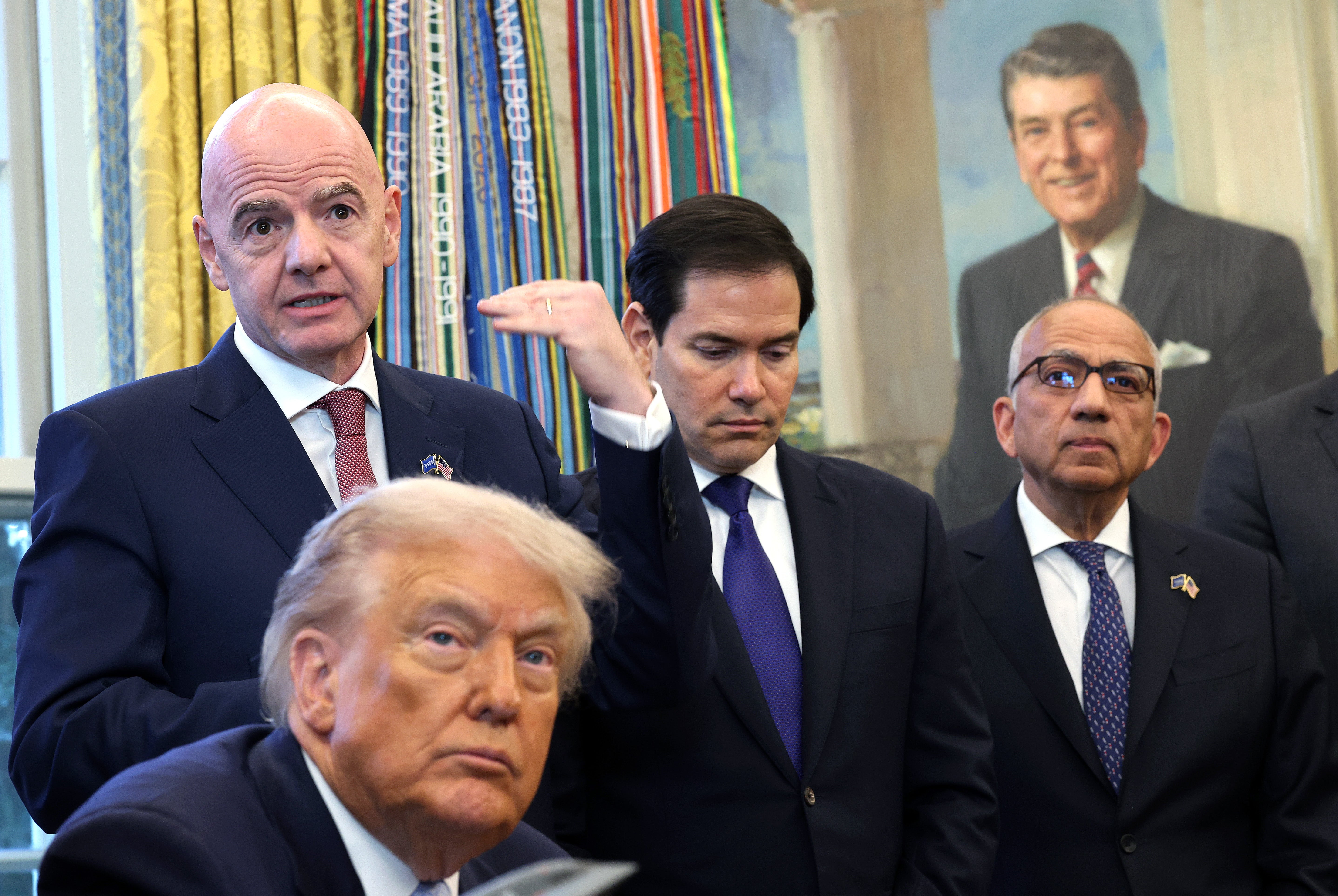 FIFA President Gianni Infantino (L), delivers remarks alongside (L-R) U.S. President Donald Trump, Secretary of State Marco Rubio and FIFA Senior Advisor for Global Strategy and Governance Carlos Cordeiro, during a meeting of the White House Task Force on the FIFA World Cup 2026 in the Oval Office of the White House on November 17, 2025 in Washington, DC
