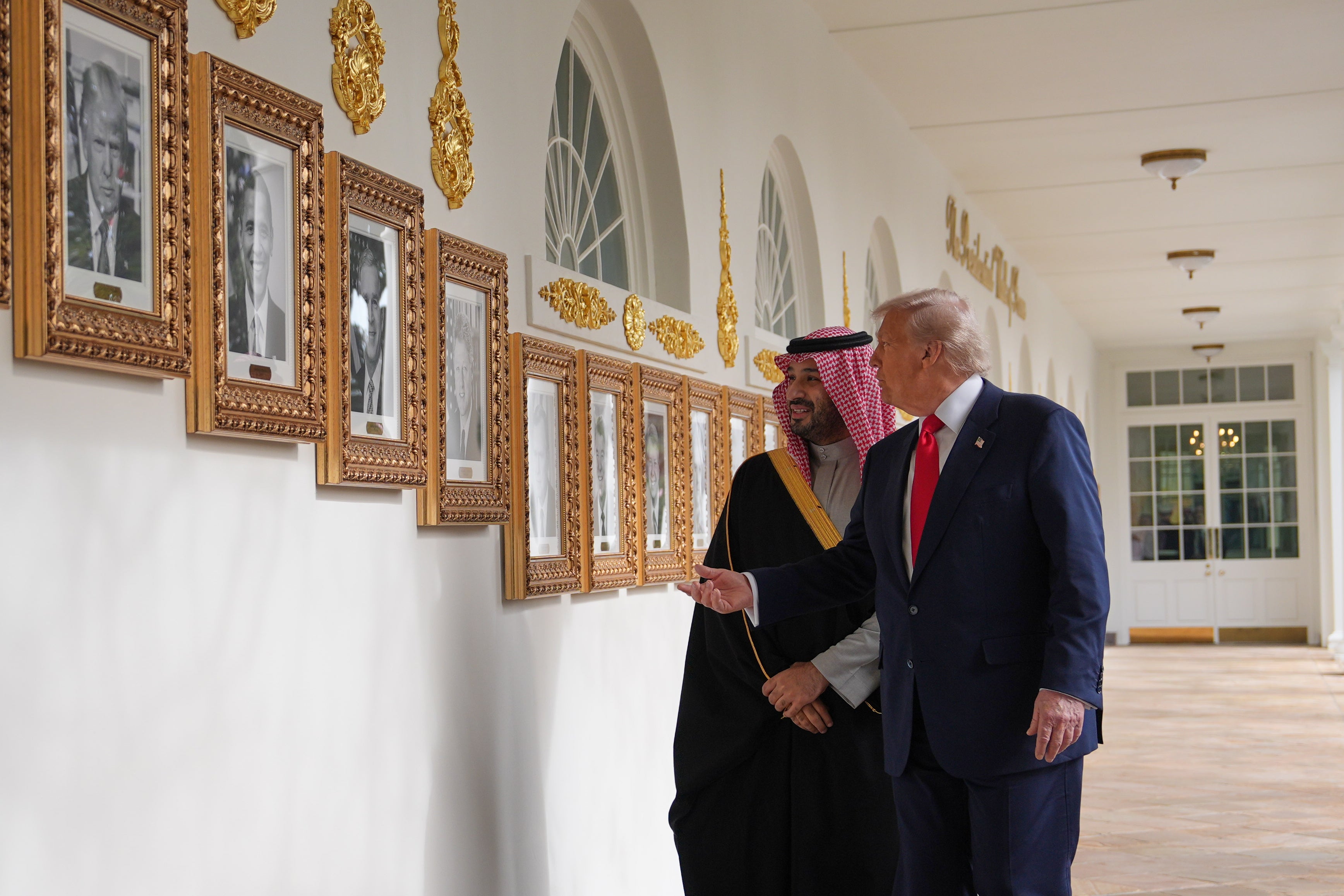 President Donald Trump shows Saudi Arabia's crown prince Mohammed bin Salman portraits of former presidents