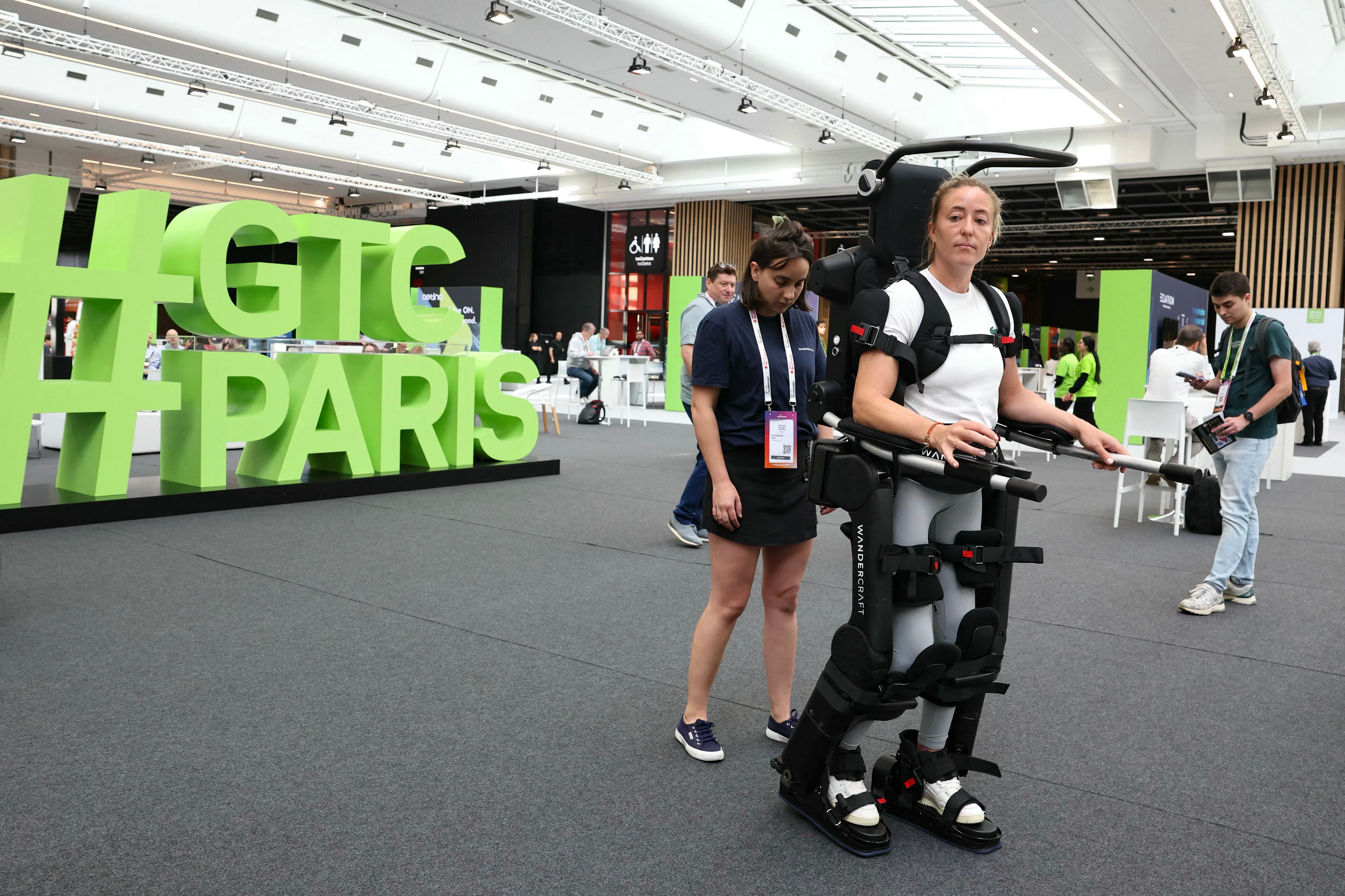 <p>A woman tries an exoskeleton at a tech innovation fair in Paris. Running up stairs in the robot-inspired suit can help improve your fitness, according to experts</p>