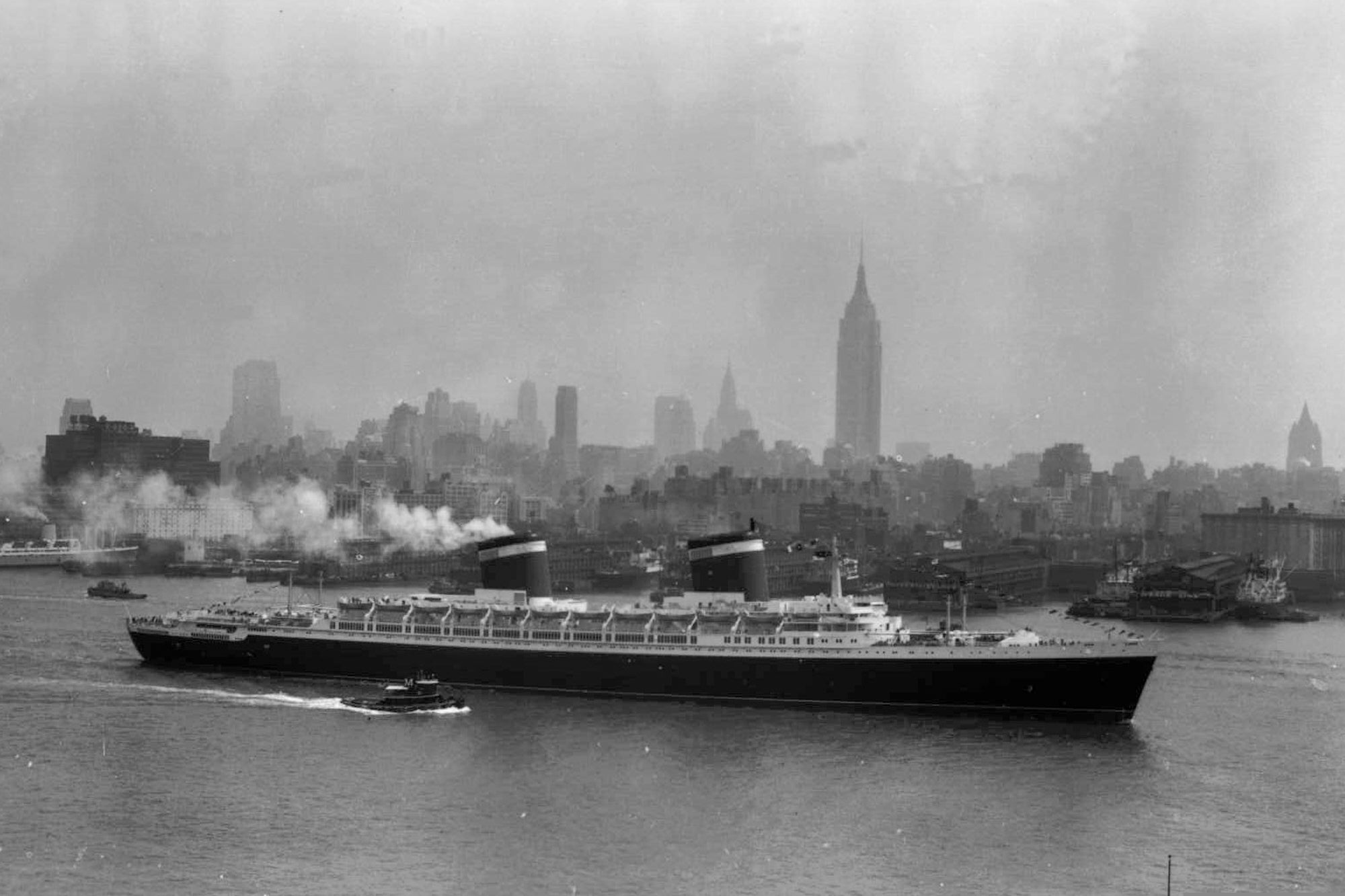 The SS United States travels along the Hudson River as it begins its first voyage to Europe from New York, July 3, 1952, with the view of the Midtown Manhattan skyline including the Empire State Building at center right. (AP Photo/Jack Harris, File)