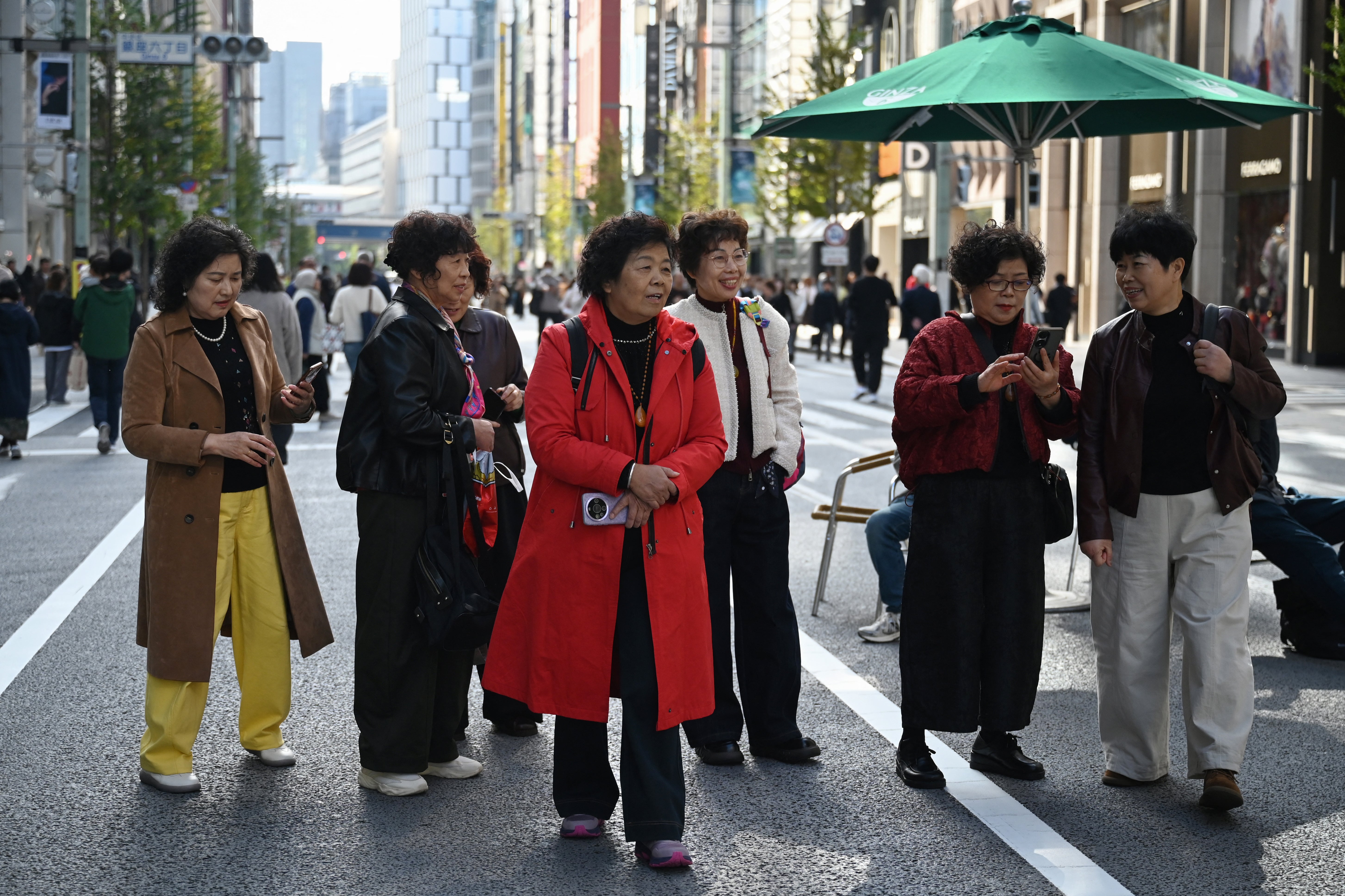 Chinese tourists tour the Ginza shopping district of Tokyo on 16 November 2025